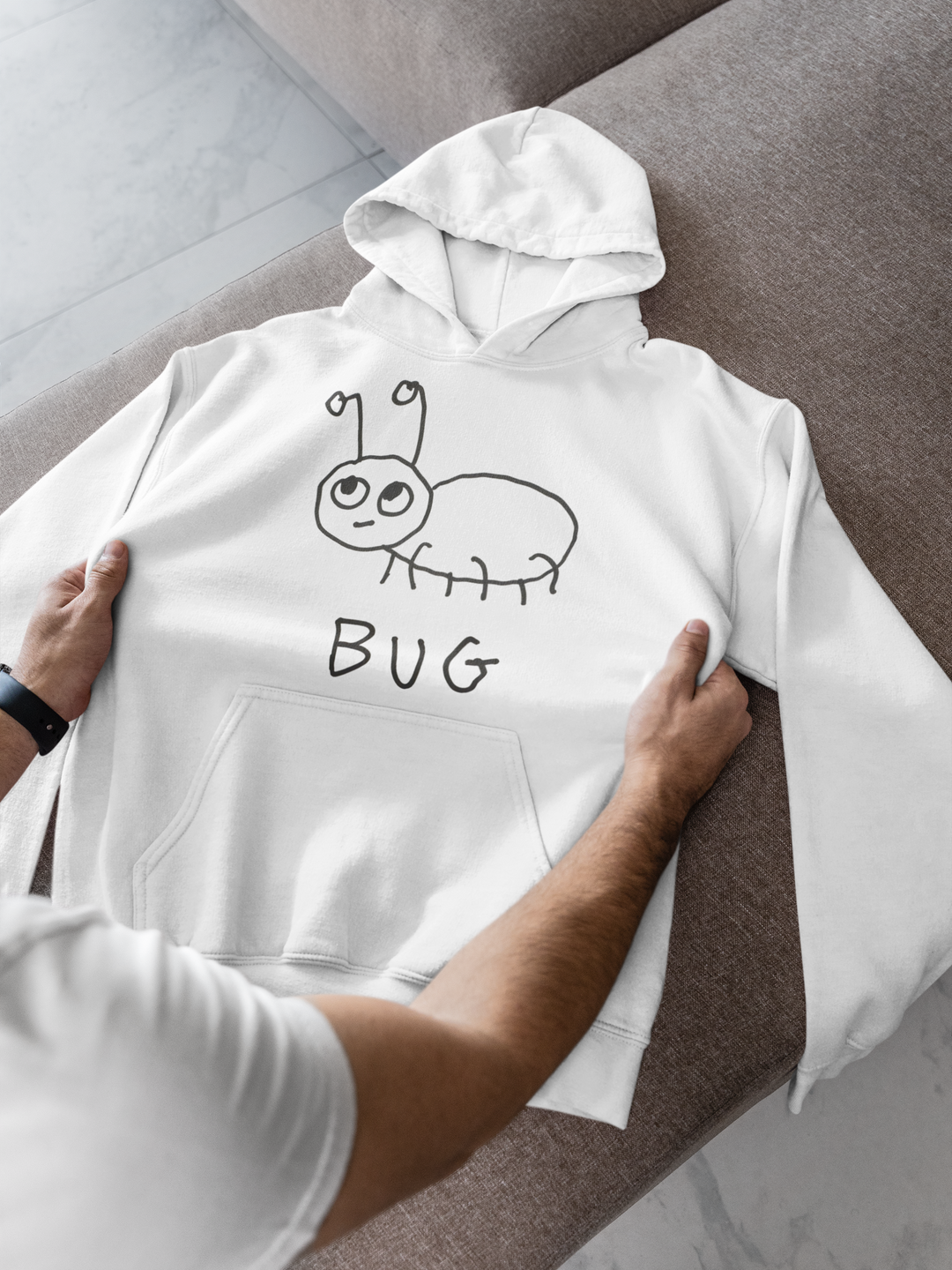 Woman wearing a white hoodie with a quirky minimalist lofi BUG drawing and text. 