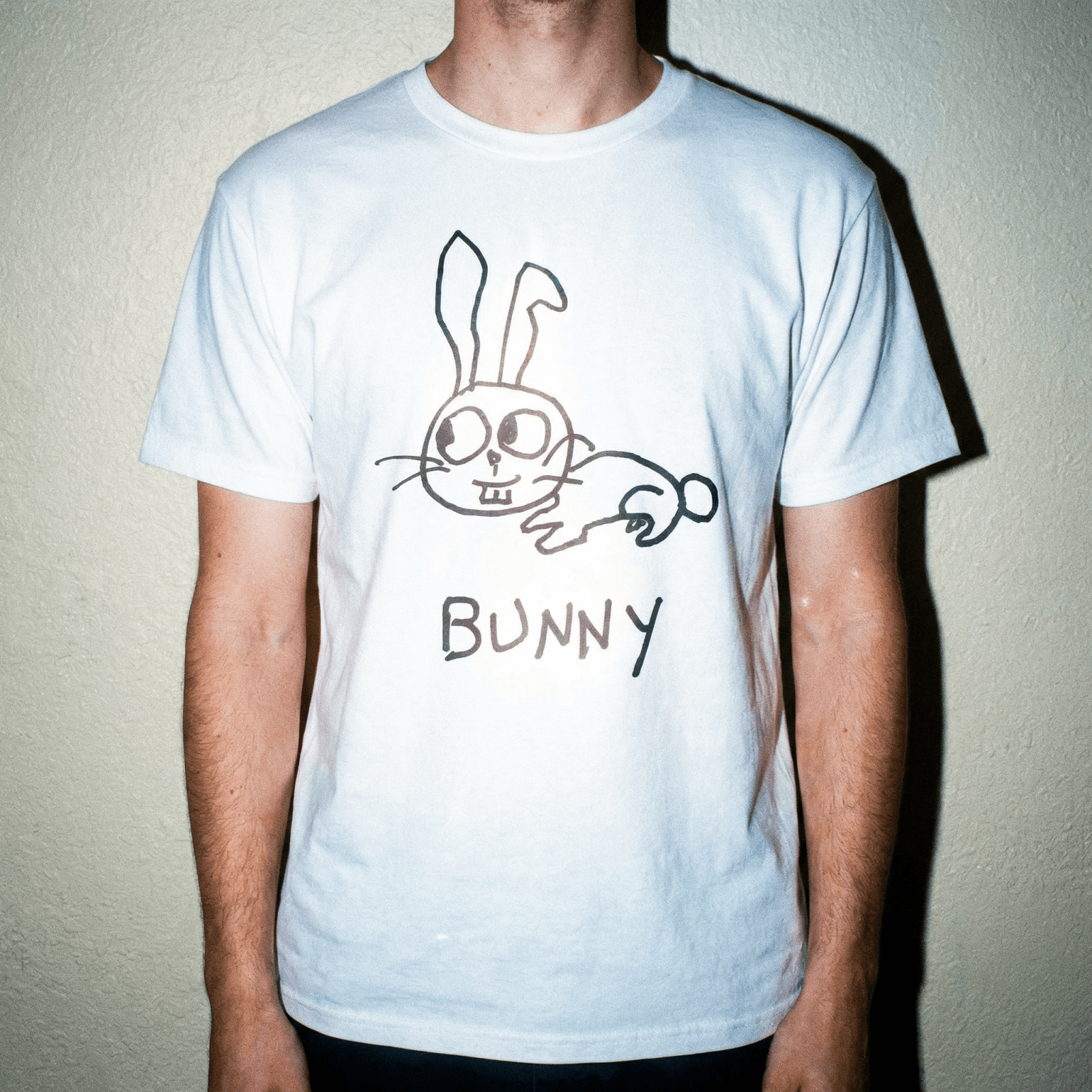 Studio torso view of a man wearing a lo-fi Bunny Classic Tee