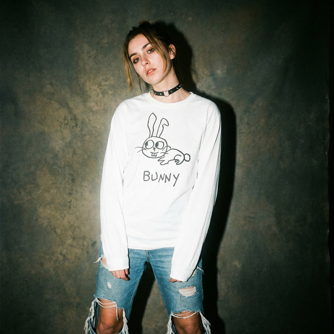 Model in a bunny graphic long sleeve in a soft-focus, pastel-toned 90s shoot