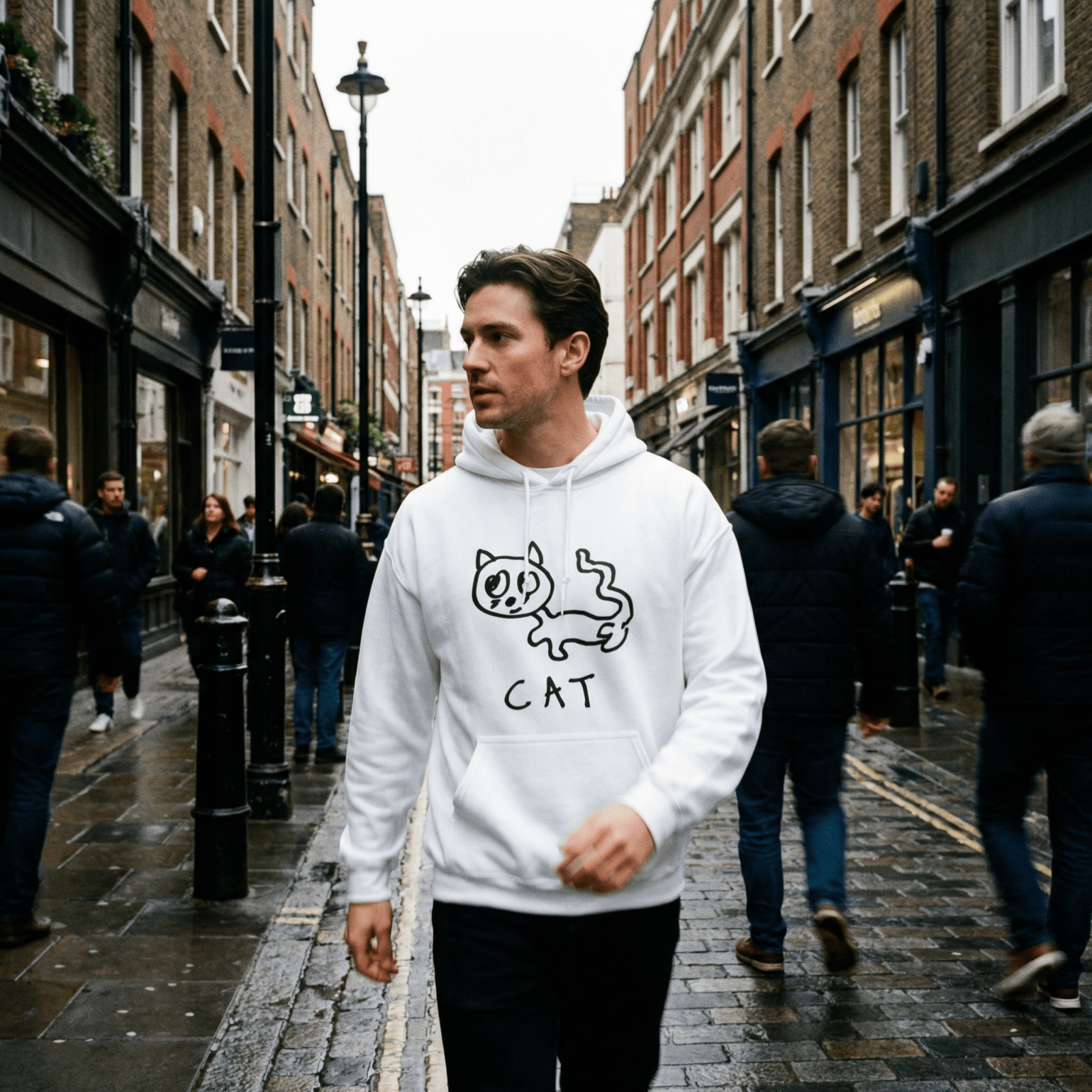 Man walking a rainy London street wearing a lo-fi Cat Hoodie