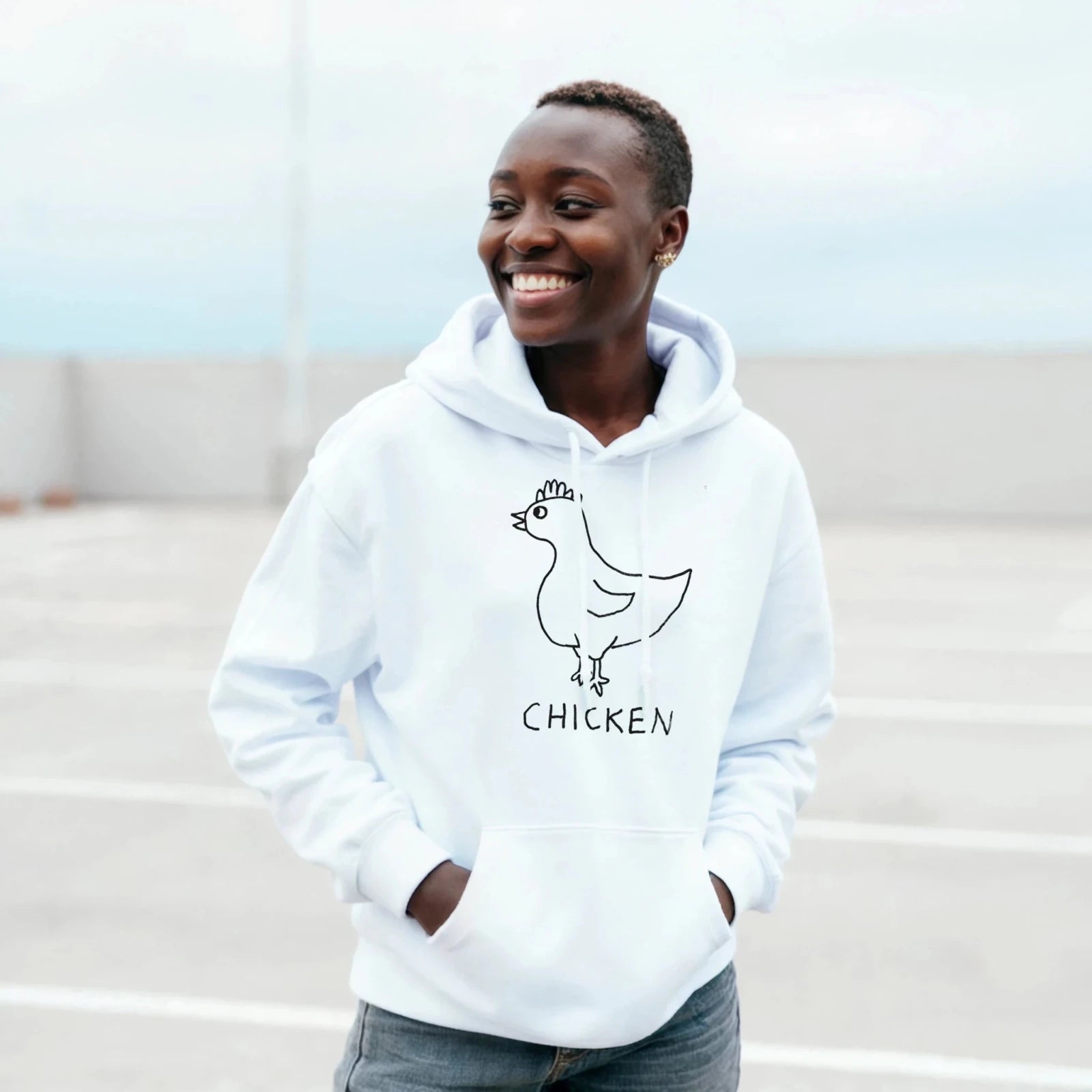 Man on a beach werinh a lo-fi Chicken Hoodie