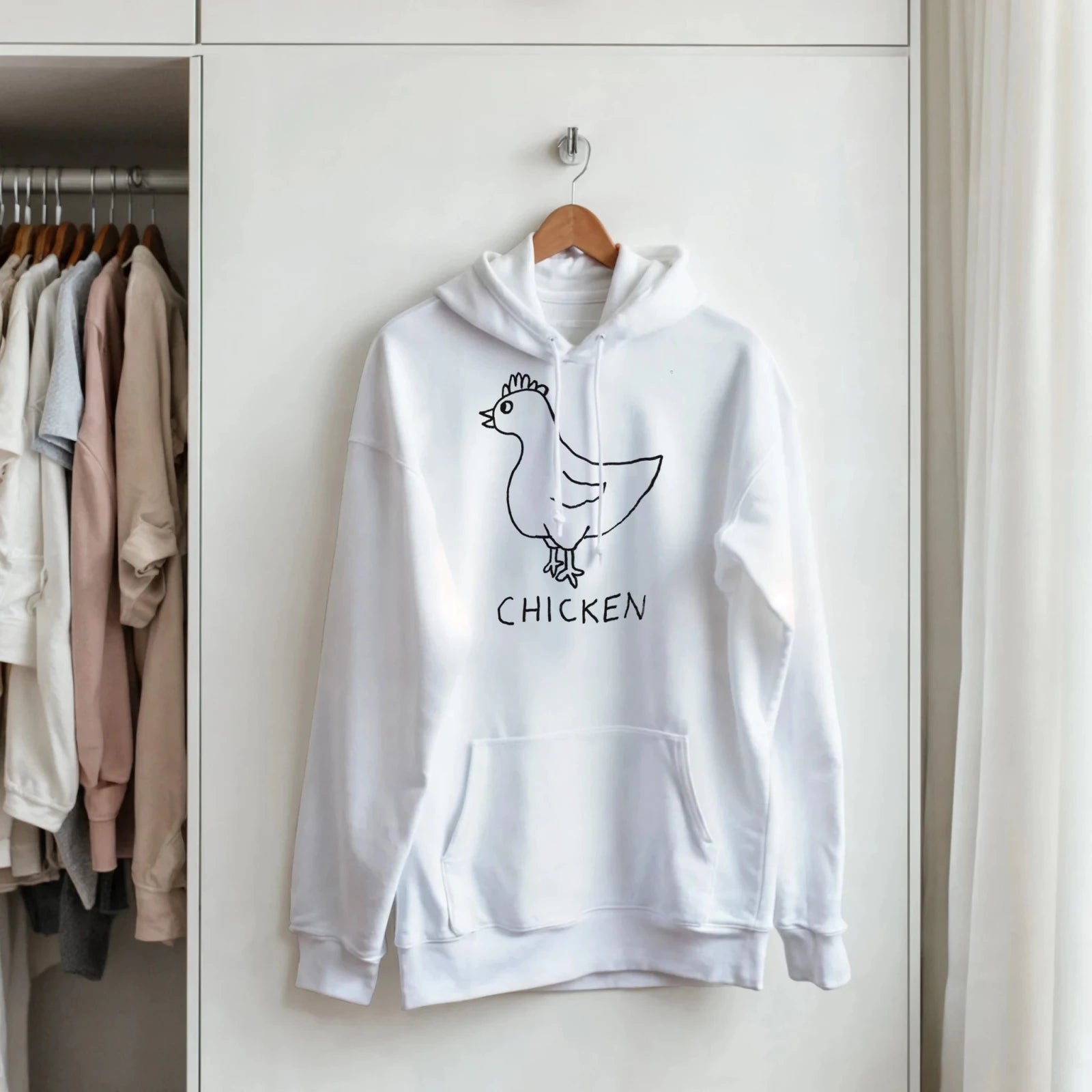 lo-fi Chicken Hoodie hanging in a closet