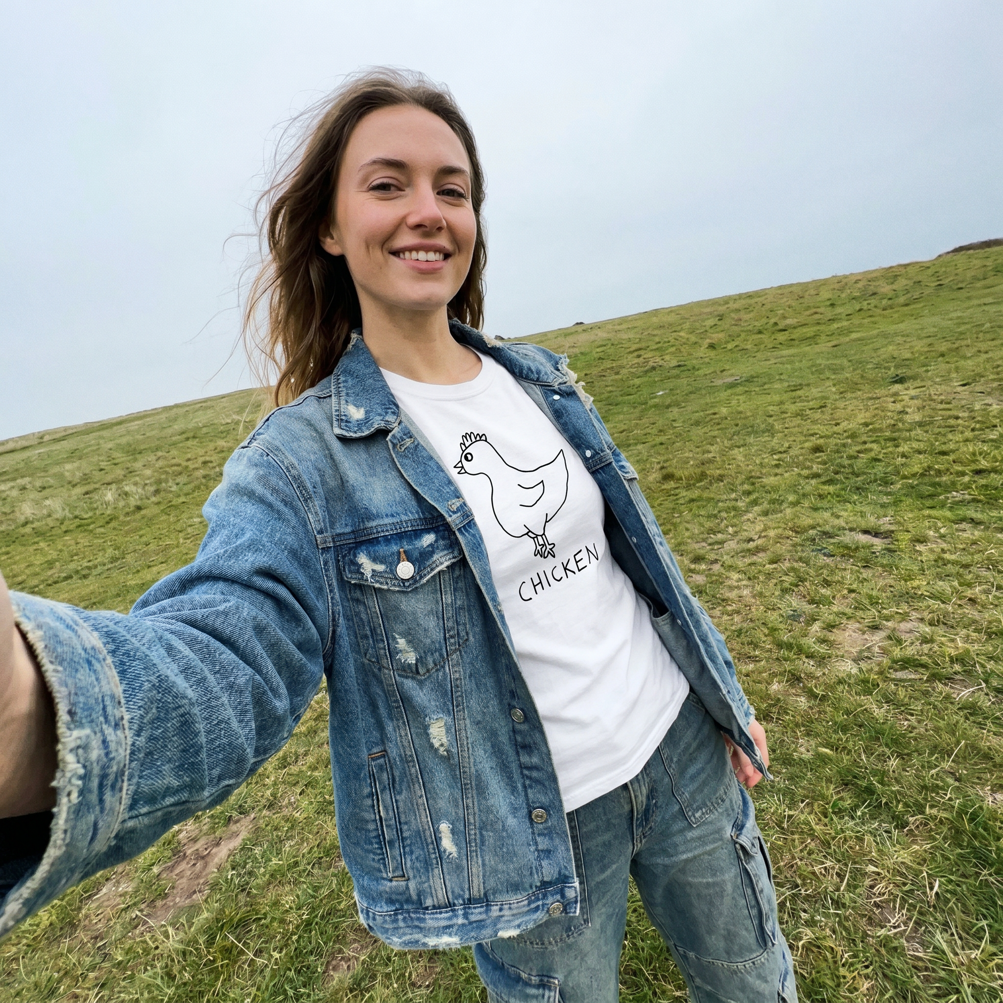 Woman taking a selfie in a field wearing a lo-fi Chicken V-Neck Tee