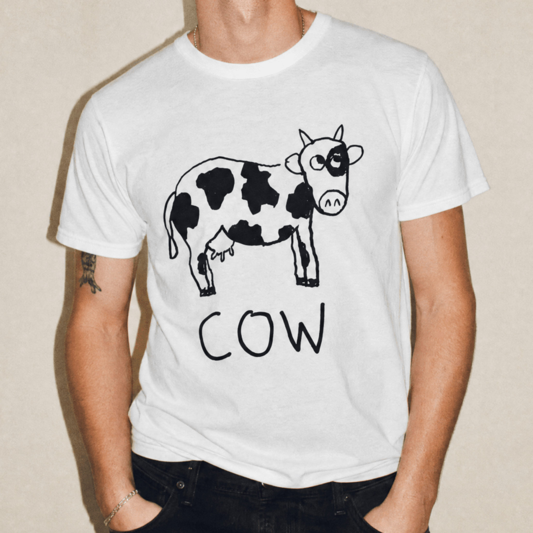 Man in a studio wearing a lo-fi Cow Classic Tee