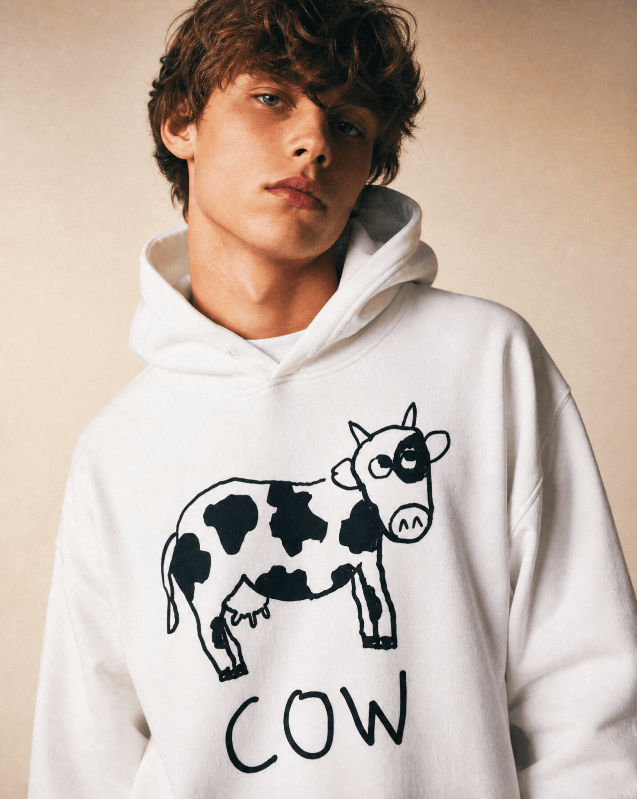 Man in a studio wearing a lo-fi Cow Hoodie