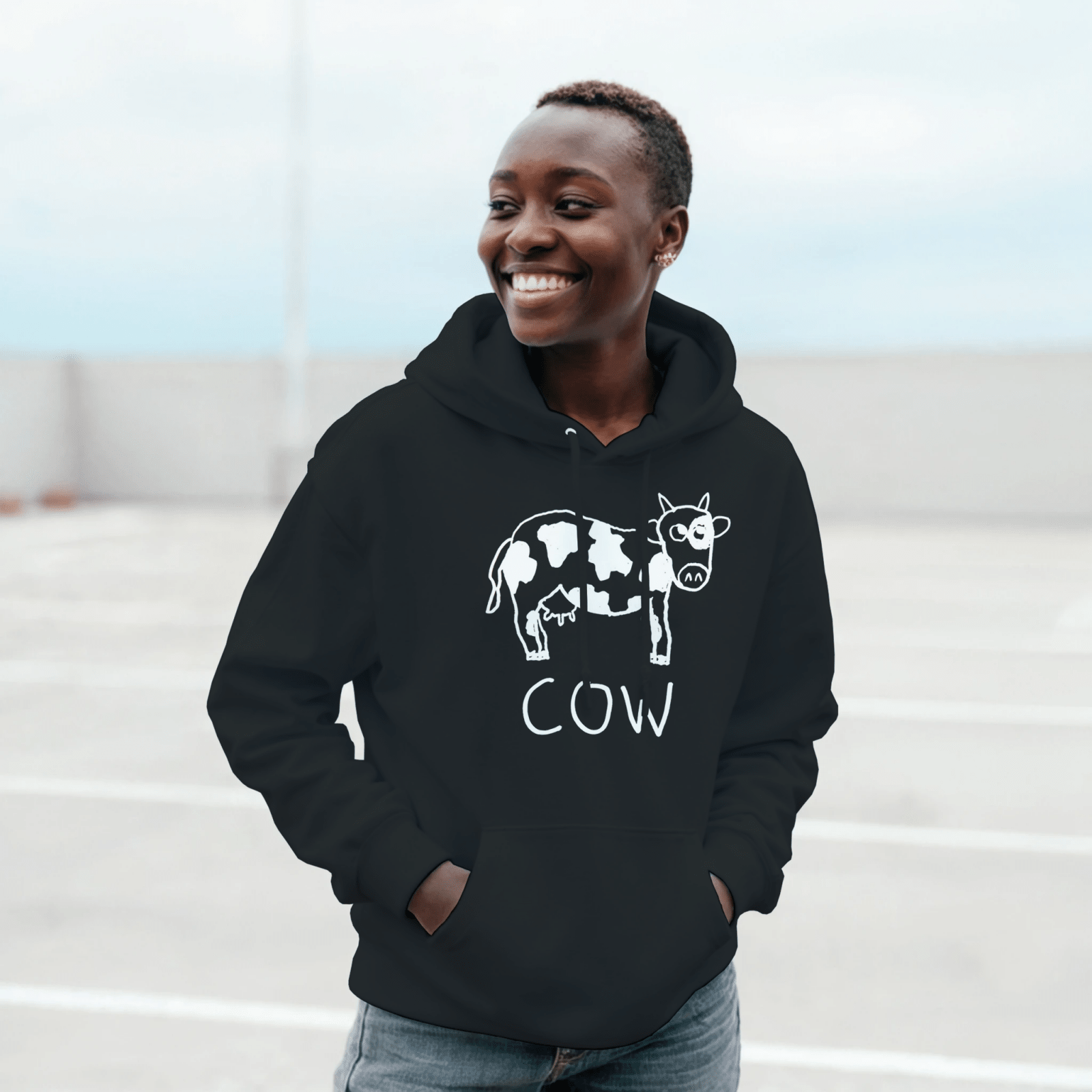 Woman on a rooftop wearing a black lo-fi Cow Hoodie