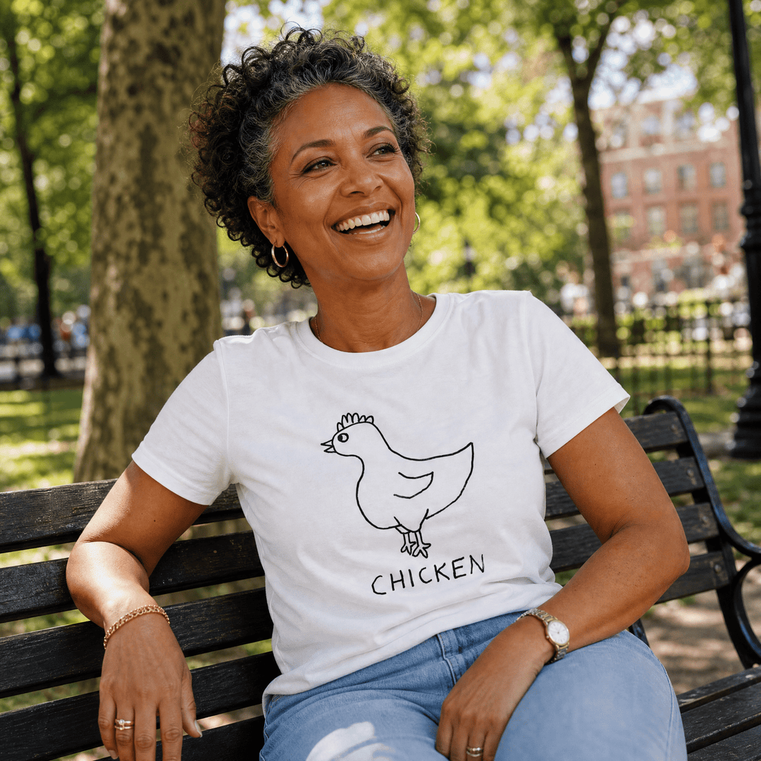 Woman seated on a park bench in a lo-fi Chicken Women&