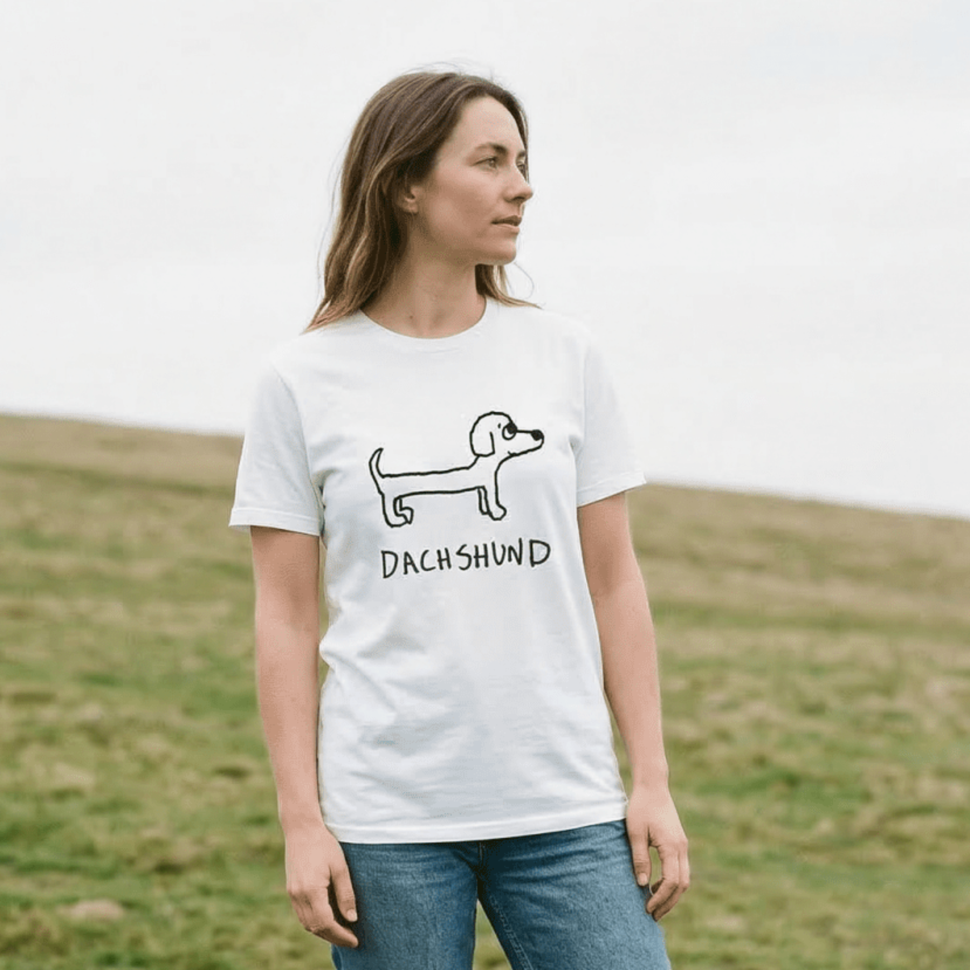 Woman standing on a grassy hill wearing a lo-fi Dachshund Classic Tee