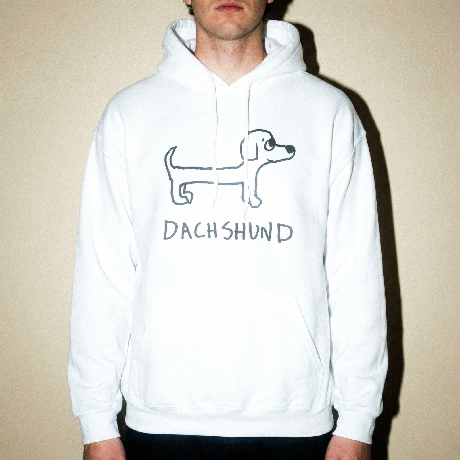Studio torso view of a man wearing a lo-fi Dachshund Hoodie