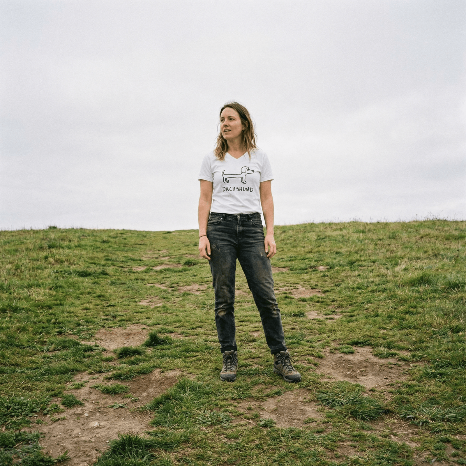 Woman standing on a grassy field wearing a lo-fi Dachshund V-Neck T-Shirt