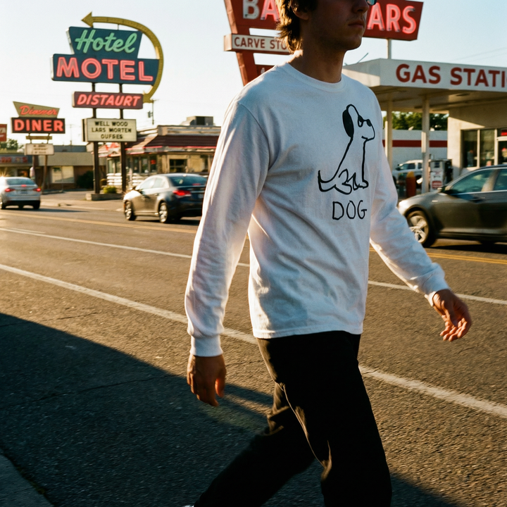 Model in a dog long sleeve tee leaning against a vintage pickup truck