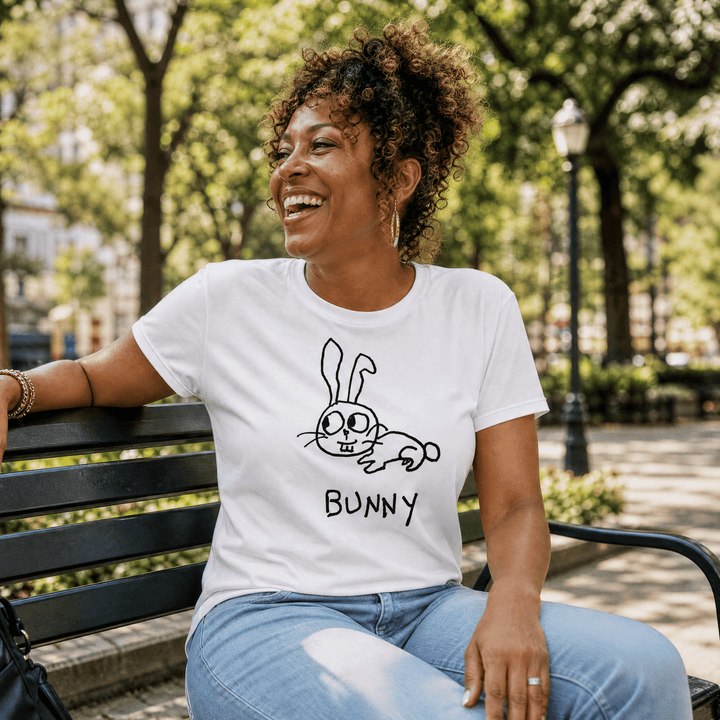 Woman seated on a park bench in a lo-fi Bunny Women&