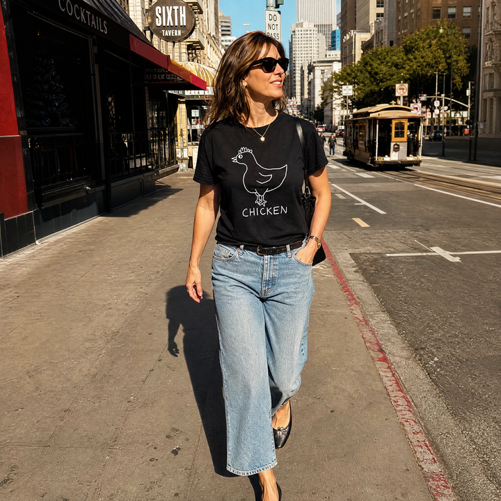Woman walking down a San Francisco street wearing a black lo-fi Chicken V-Neck Tee
