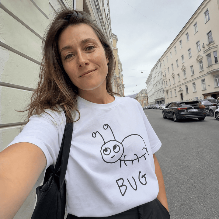 Woman taking a street selfie in a lo-fi Bug Women&