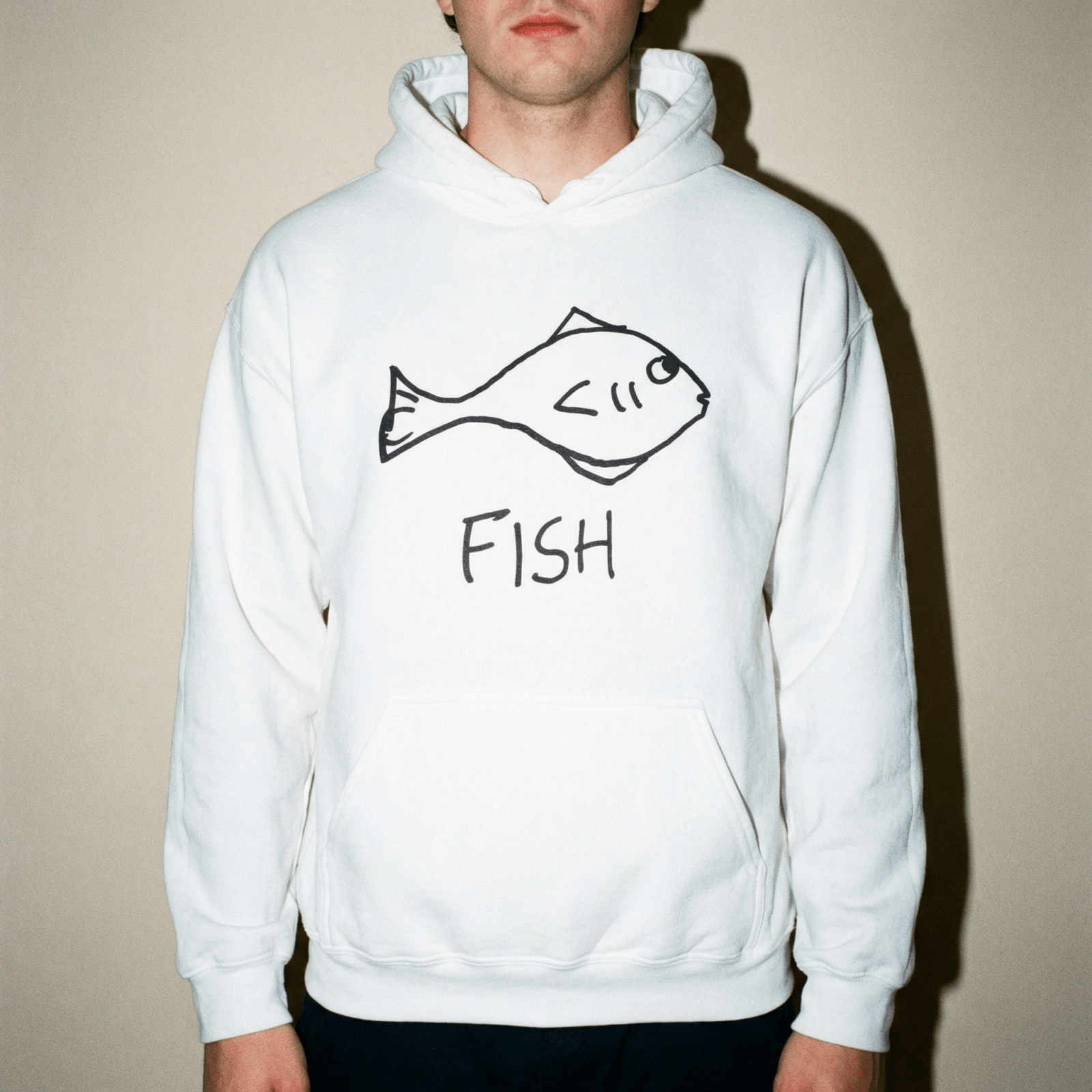 Studio portrait of a man wearing a lo-fi Fish Hoodie