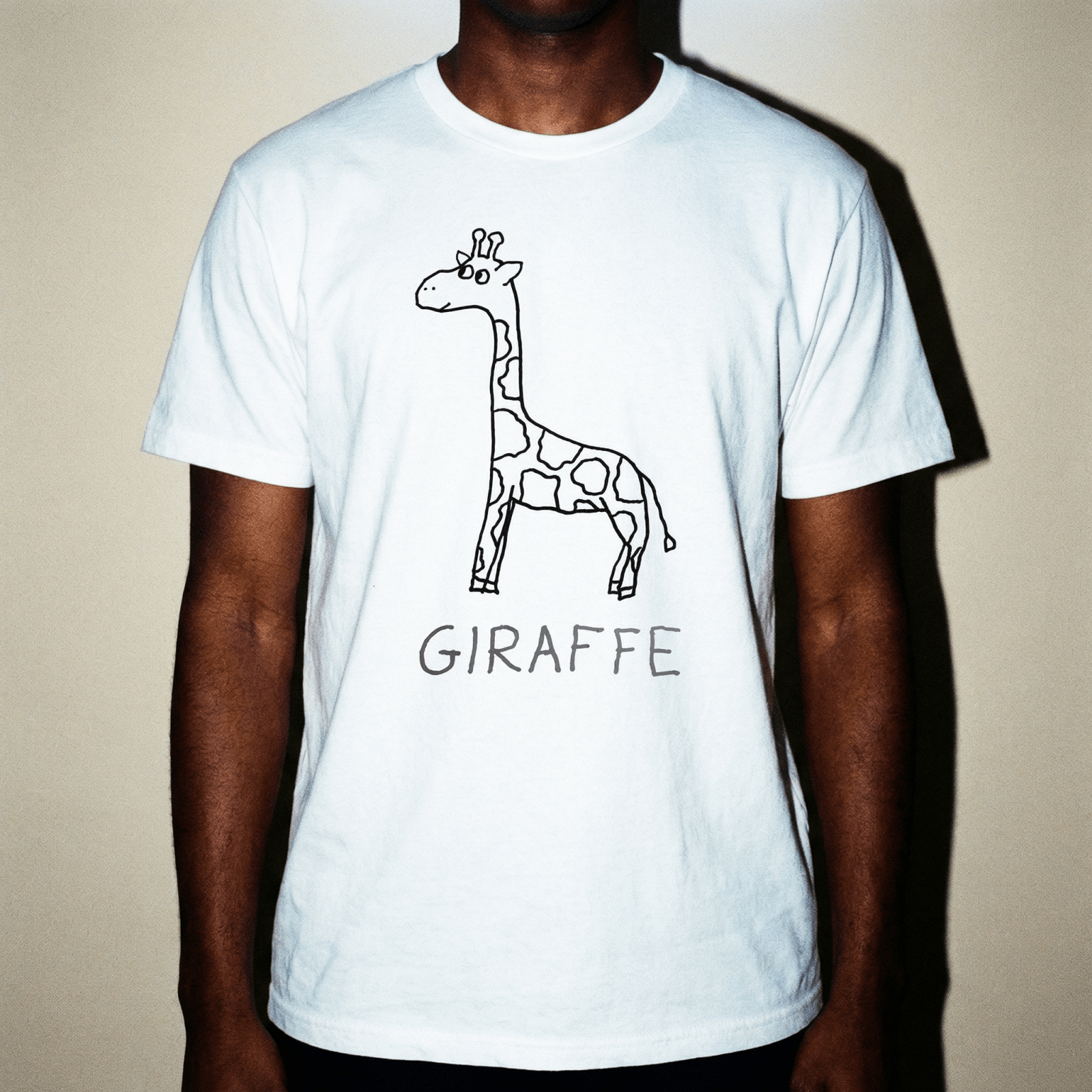 Man in a studio portrait wearing a lo-fi Giraffe Classic Tee in white