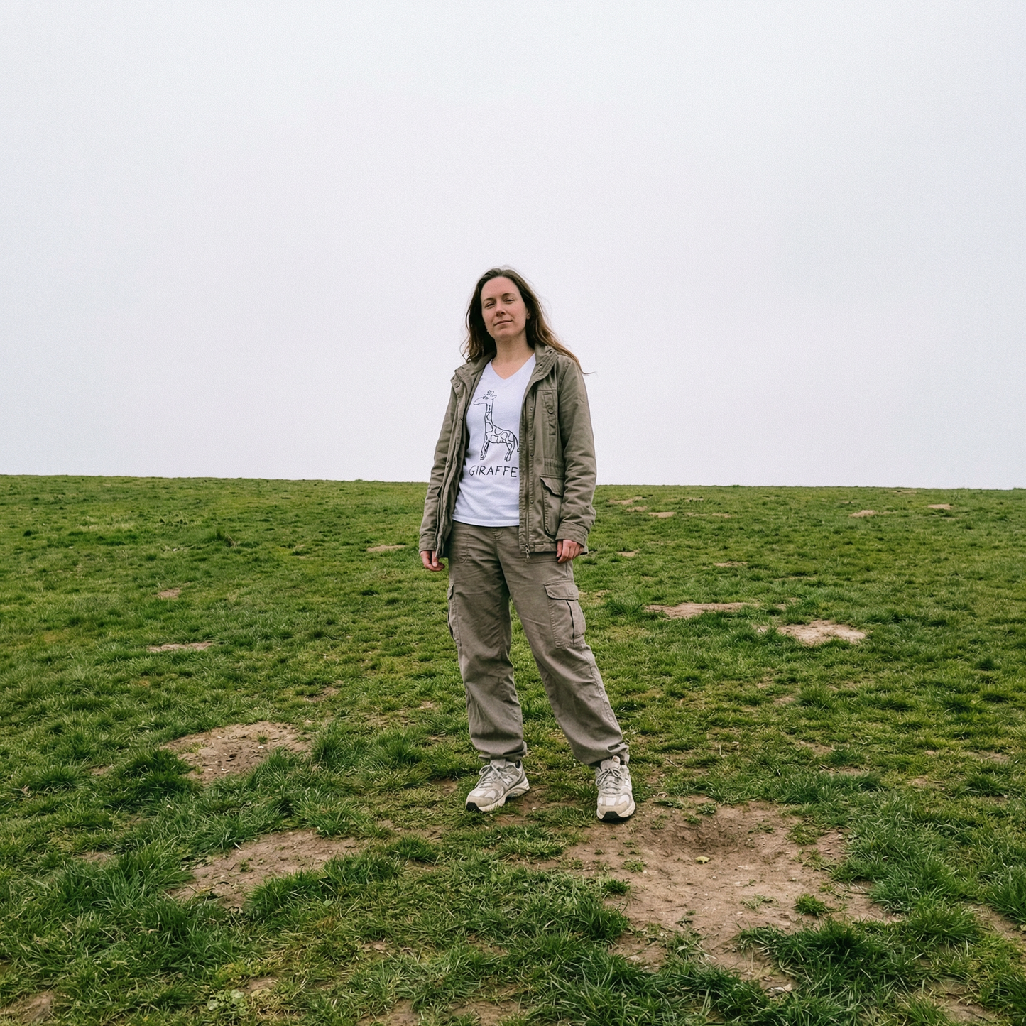 Model in giraffe v-neck tee in a sprawling field, golden afternoon light