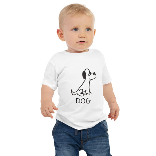 toddler standing against white background wearing toddler t-shirt featuring a crude but cute black and white marker marker drawing of a cute dog with the word "DOG" handwritten underneath