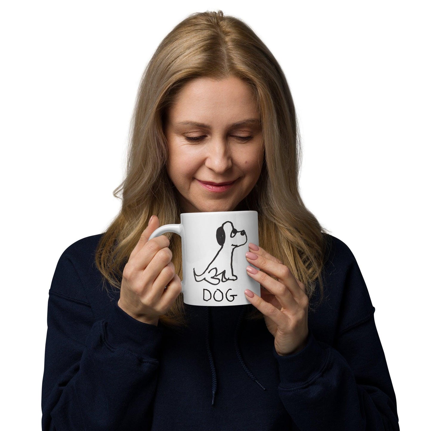 a woman looking down into her white coffee mug  featuring a crude marker black and white marker drawing of a cute dog with the word "DOG" handwritten underneath