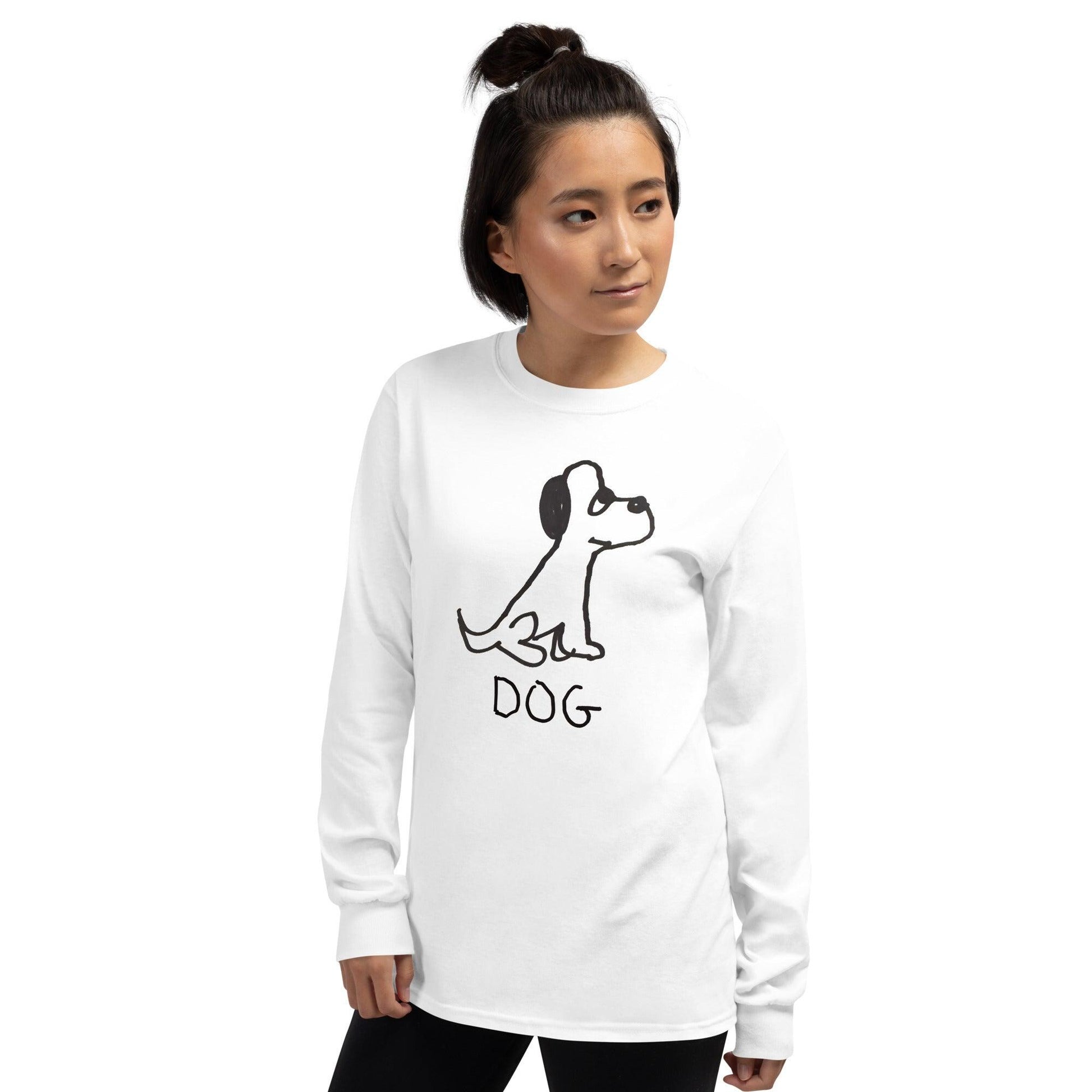 hip young woman on a white background wearing a long sleeve white t-shirt featuring a crude marker black and white marker drawing of a cute dog with the word "DOG" handwritten underneath