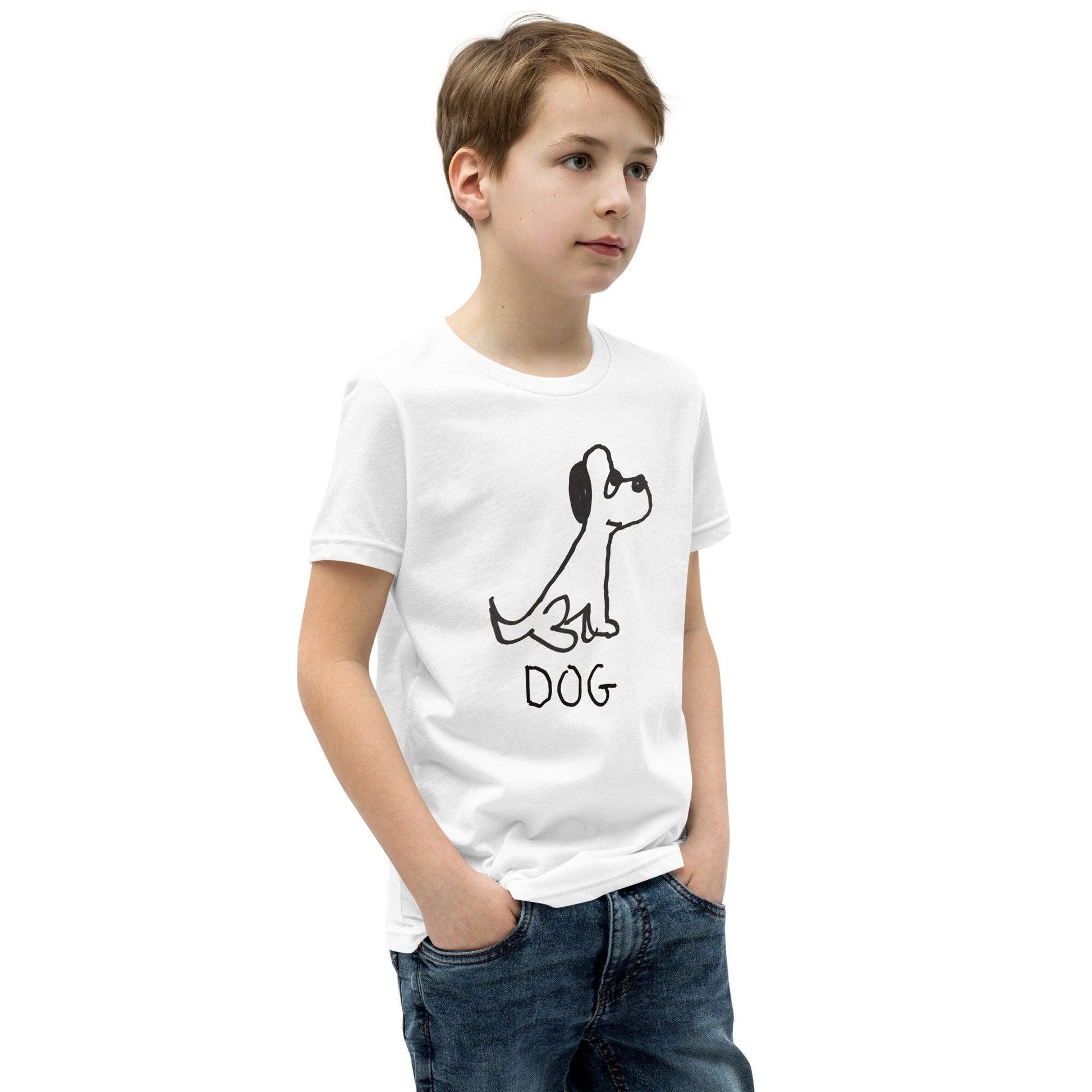 young boy wearing a white t-shirt featuring a crude marker black and white marker drawing of a cute dog with the word "DOG" handwritten underneath