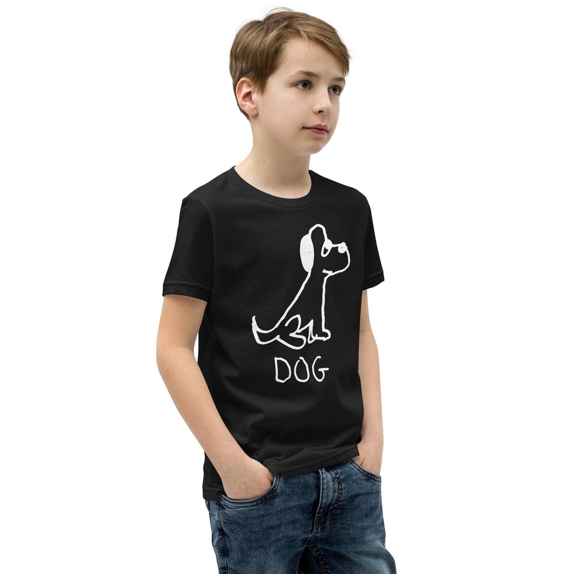 young boy wearing a black t-shirt featuring a crude marker black and white marker drawing of a cute dog with the word "DOG" handwritten underneath