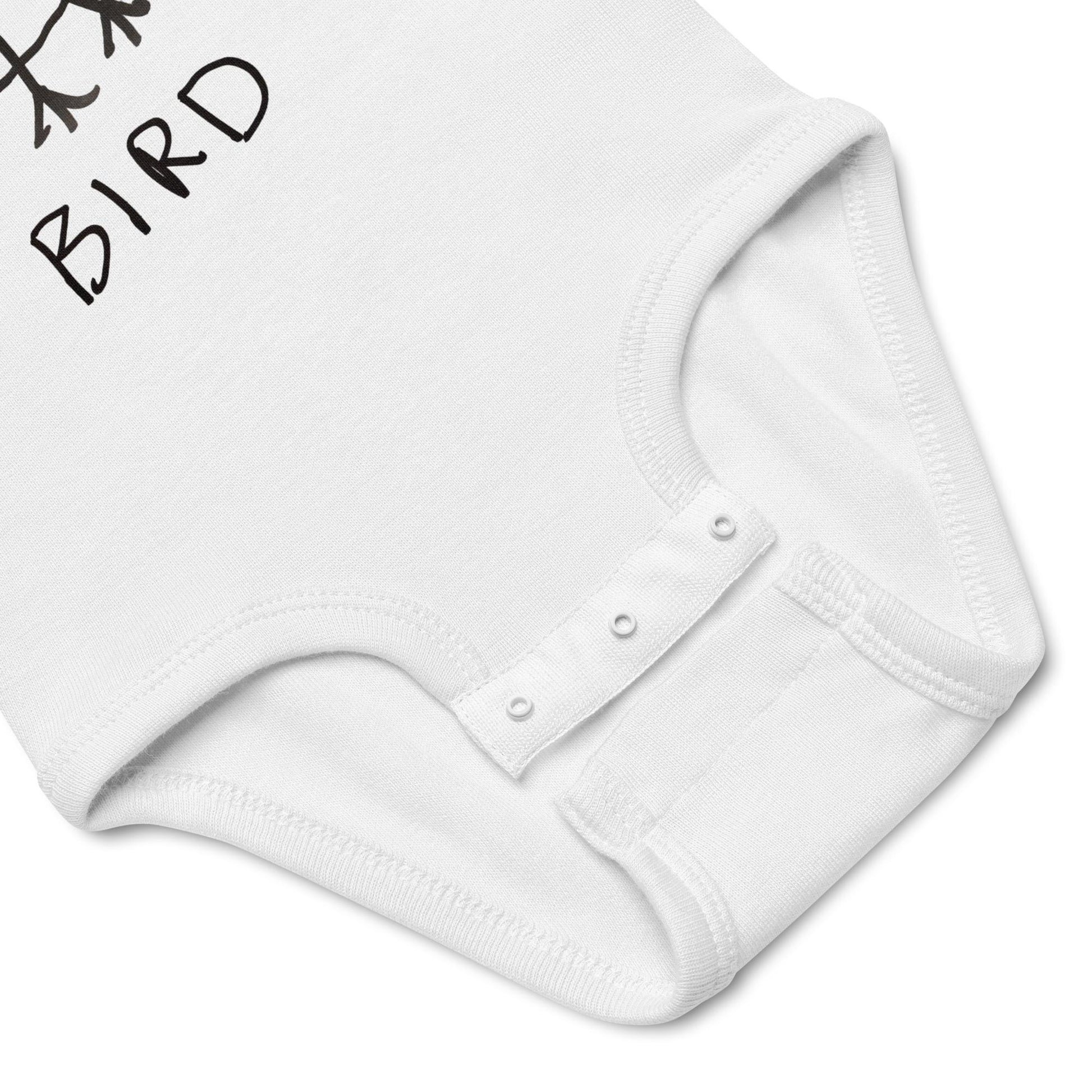 White baby onesie with a small bird design on a white background
