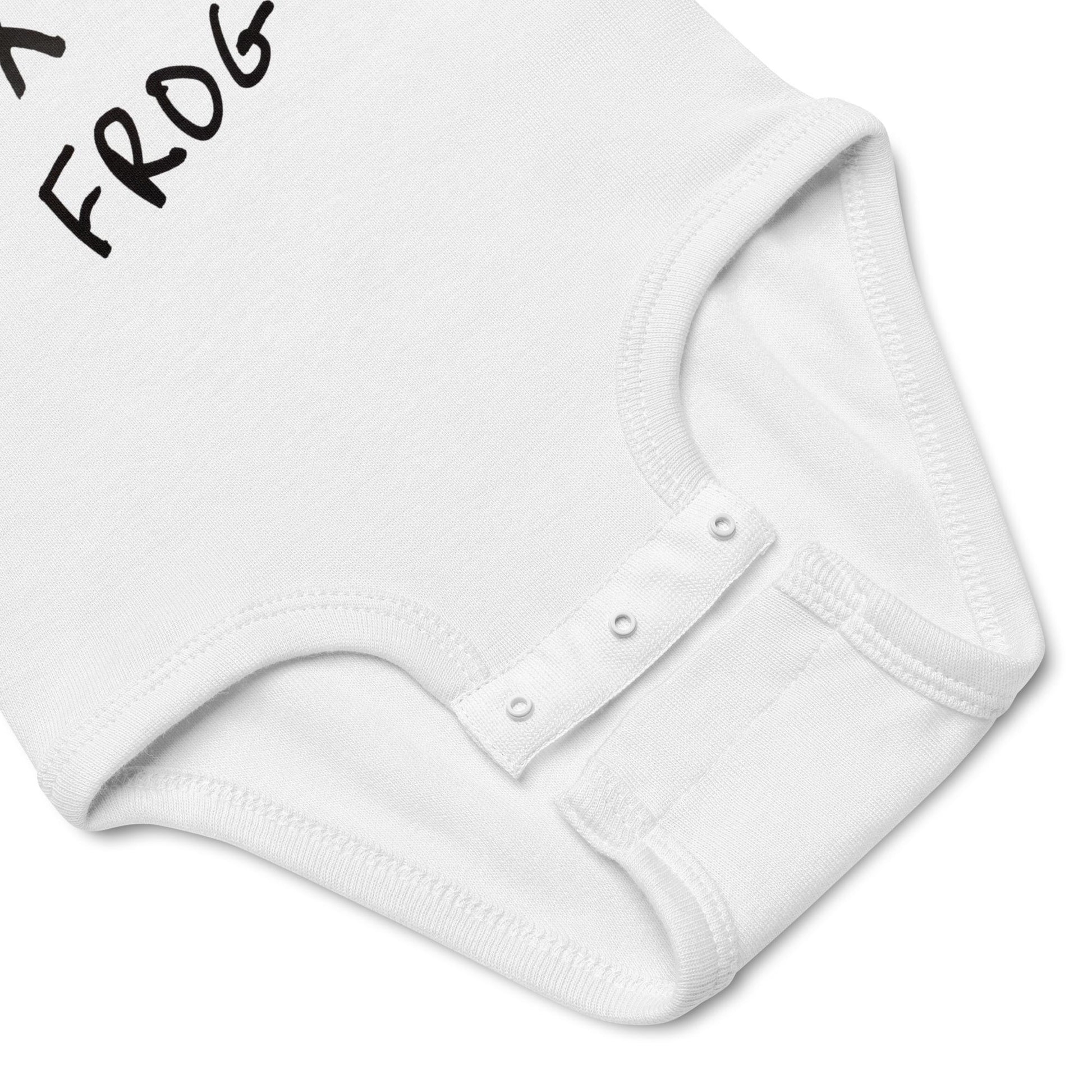 White baby onesie with 'FROG' text on a light gray background