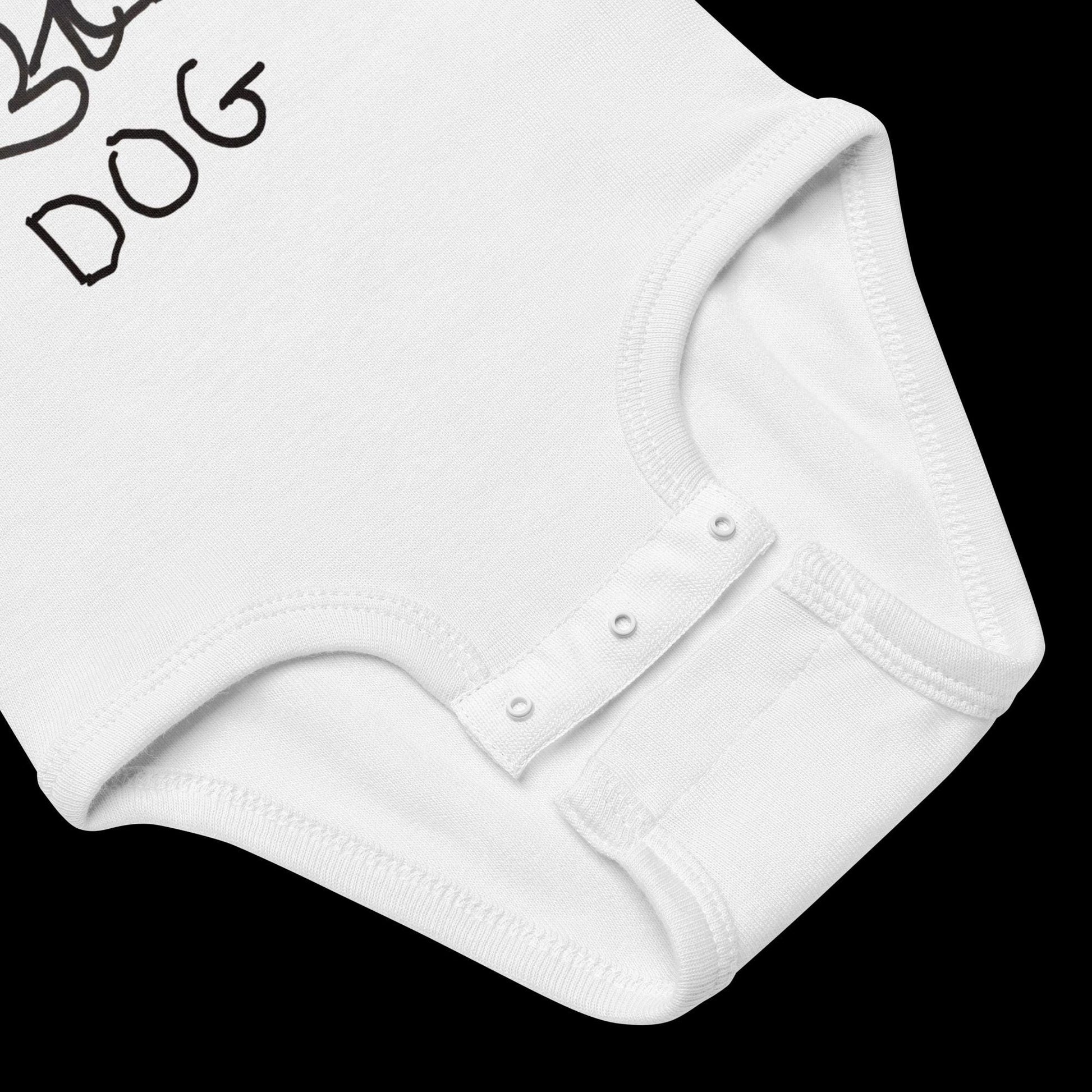 closeup of baby onsie featuring a crude marker black and white marker drawing of a cute dog with the word "DOG" handwritten underneath
