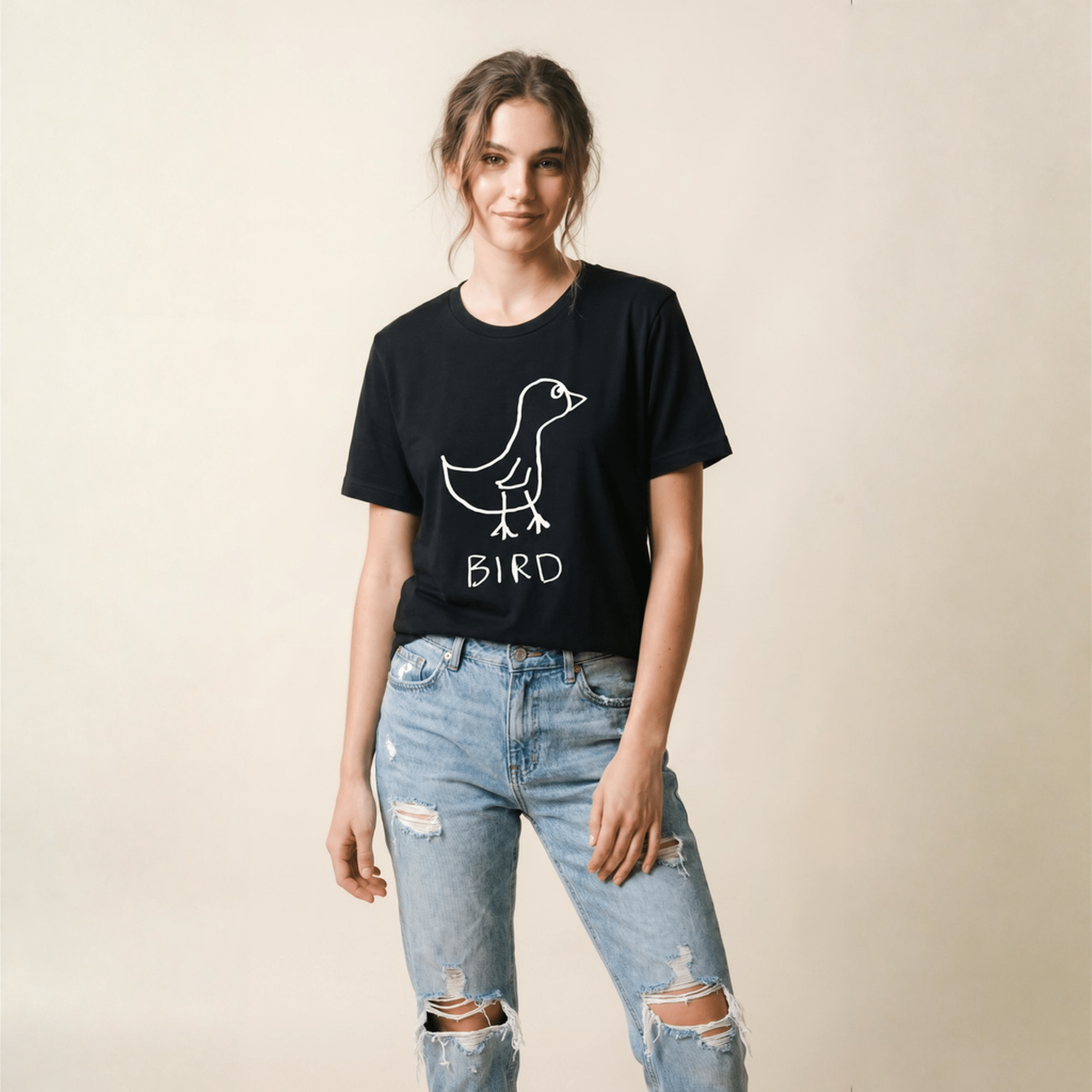 Woman in a studio portrait wearing a lo-fi Bird Women's Relaxed T-Shirt in black