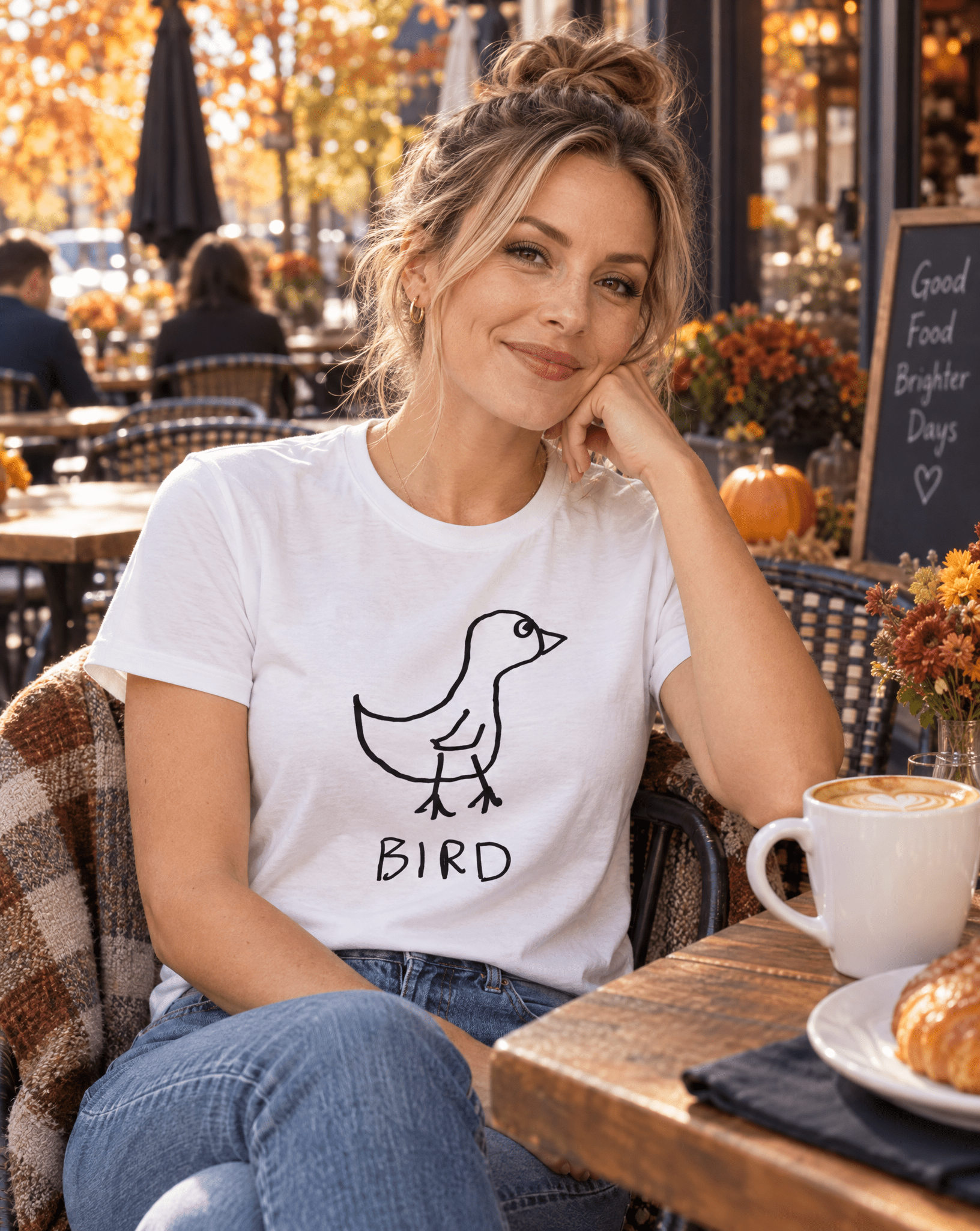 Sep 29 bird women's tee — autumn patio lifestyle photo