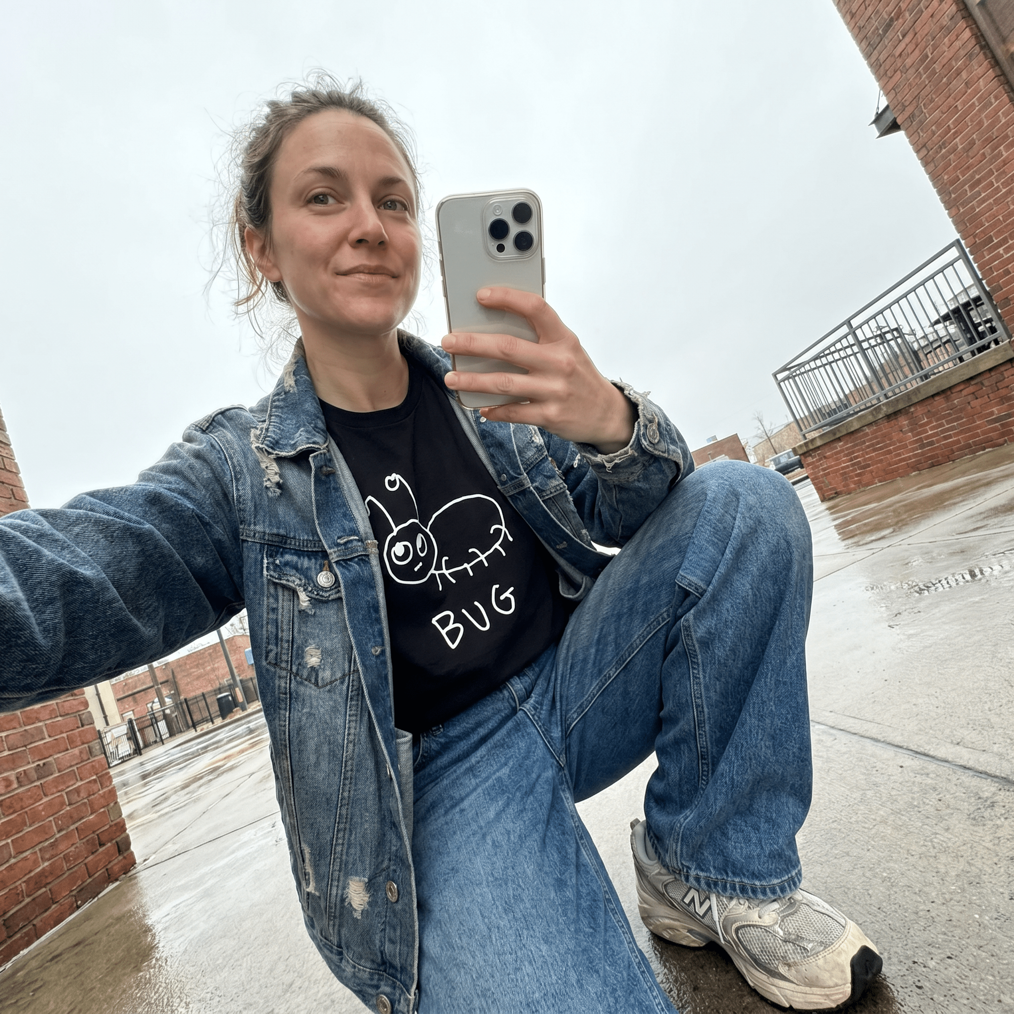Woman taking a street selfie in a lo-fi Bug Women's Relaxed T-Shirt in black