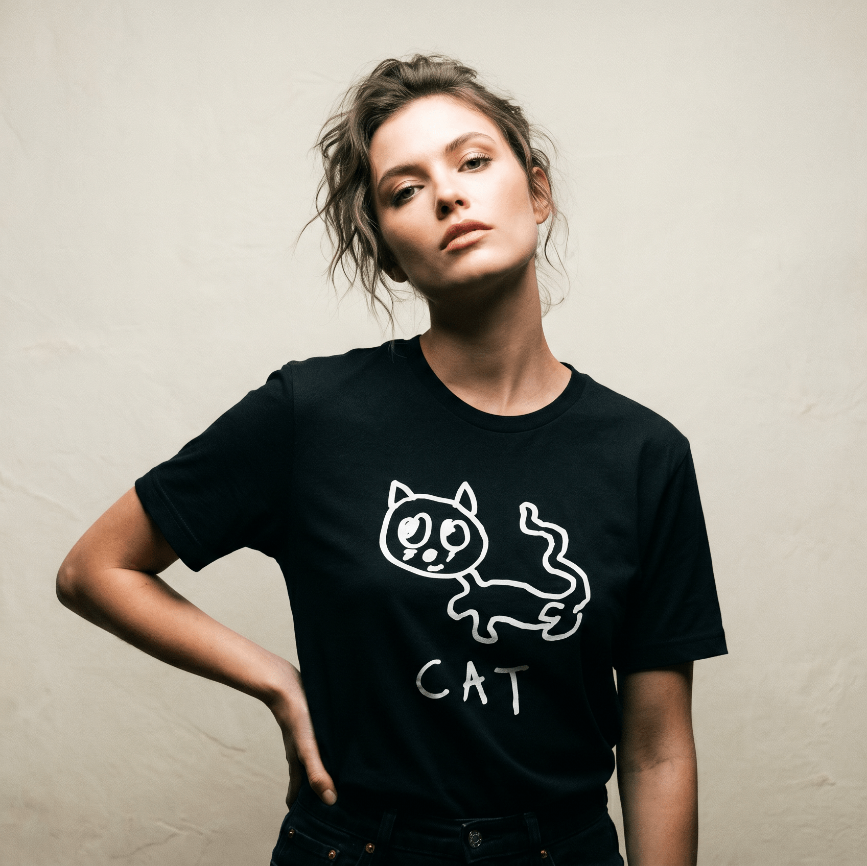Woman in a minimalist studio portrait wearing a lo-fi Cat Women's Relaxed T-Shirt in black