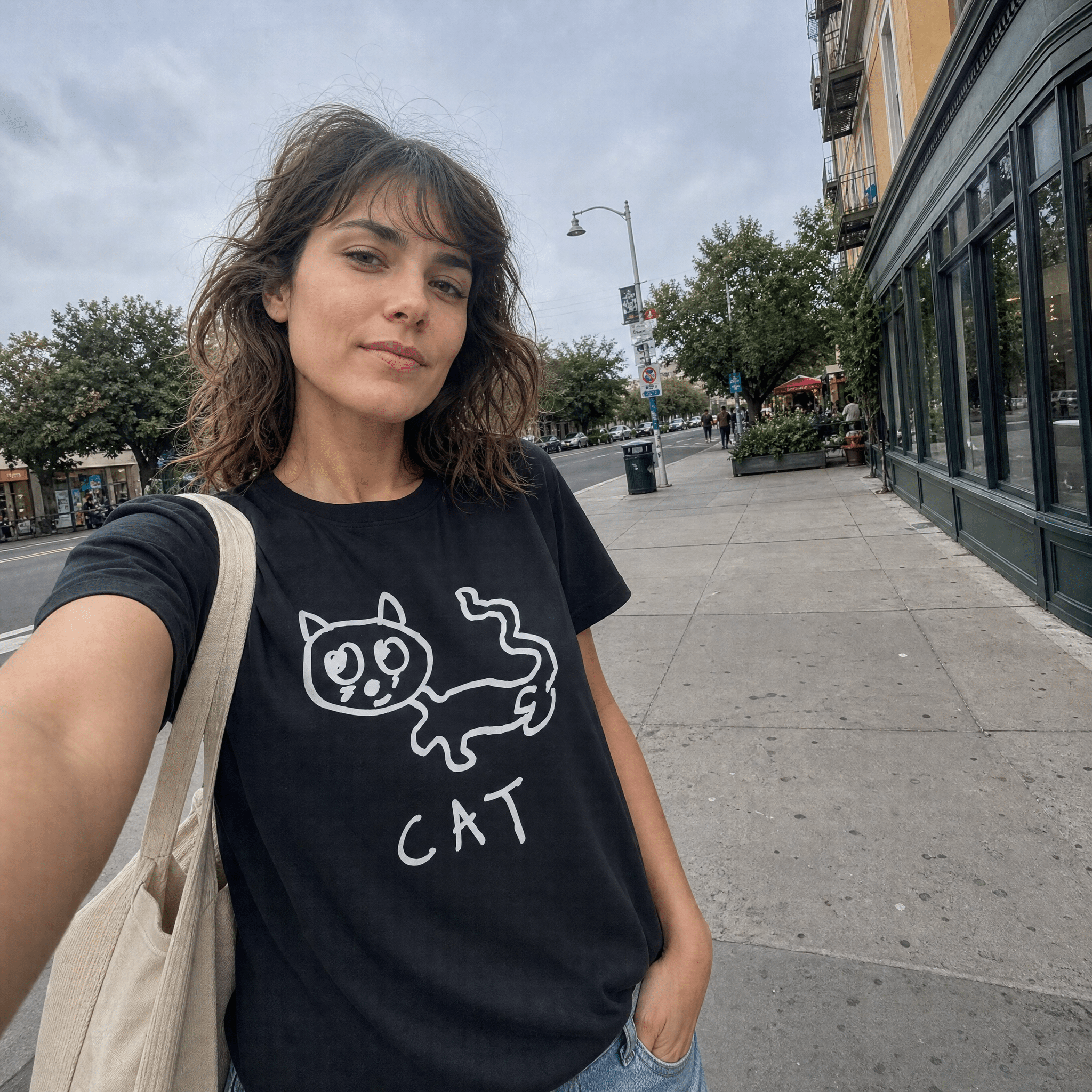 Woman taking a street selfie in a lo-fi Cat Women's Relaxed T-Shirt in black