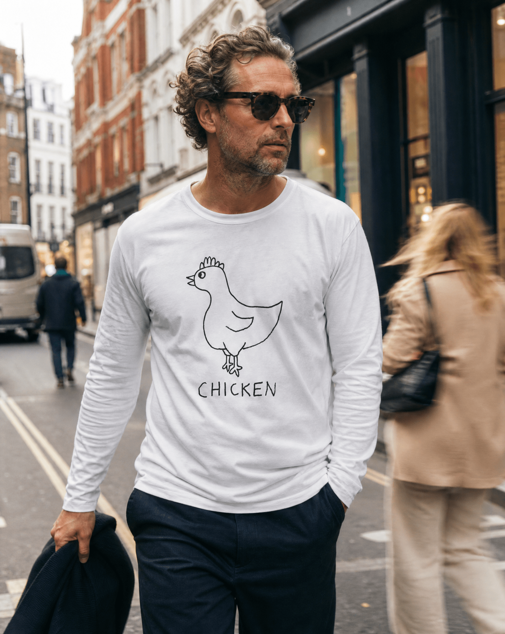 Woman walking a SoHo shopping street in a lo-fi Chicken Long Sleeve Tee in white