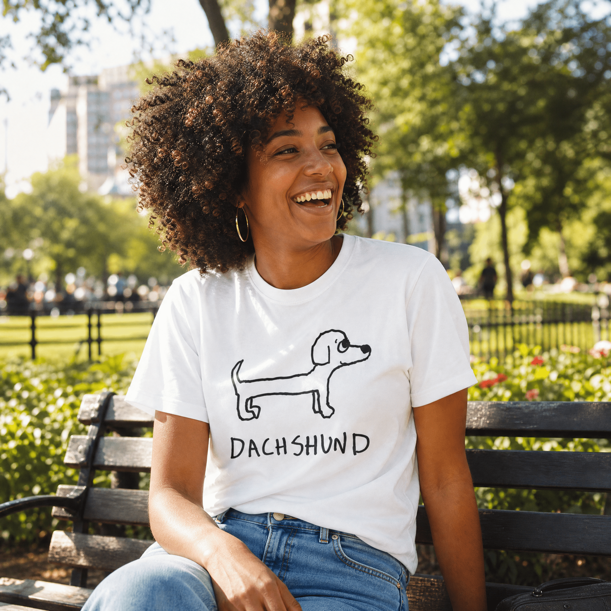 Woman laughing on a park bench at a farmers market wearing a lo-fi Dachshund Classic Tee