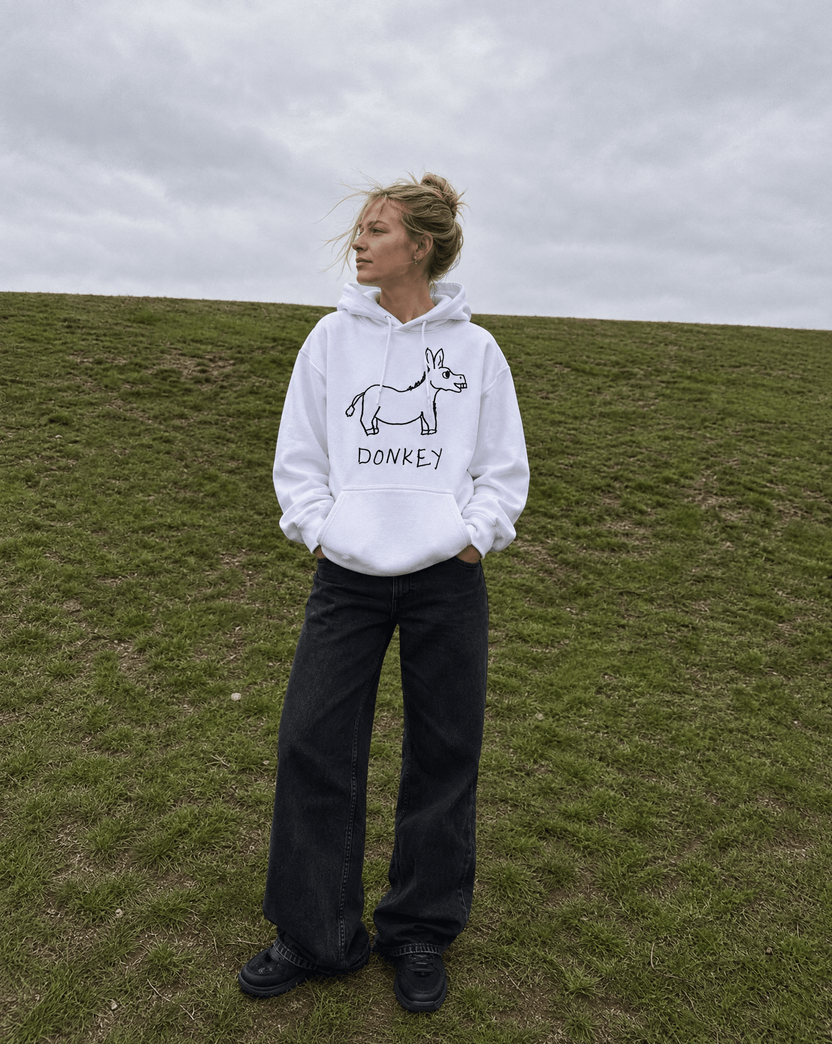 LoFi Donkey Hoodie lifestyle photo — grassy hill