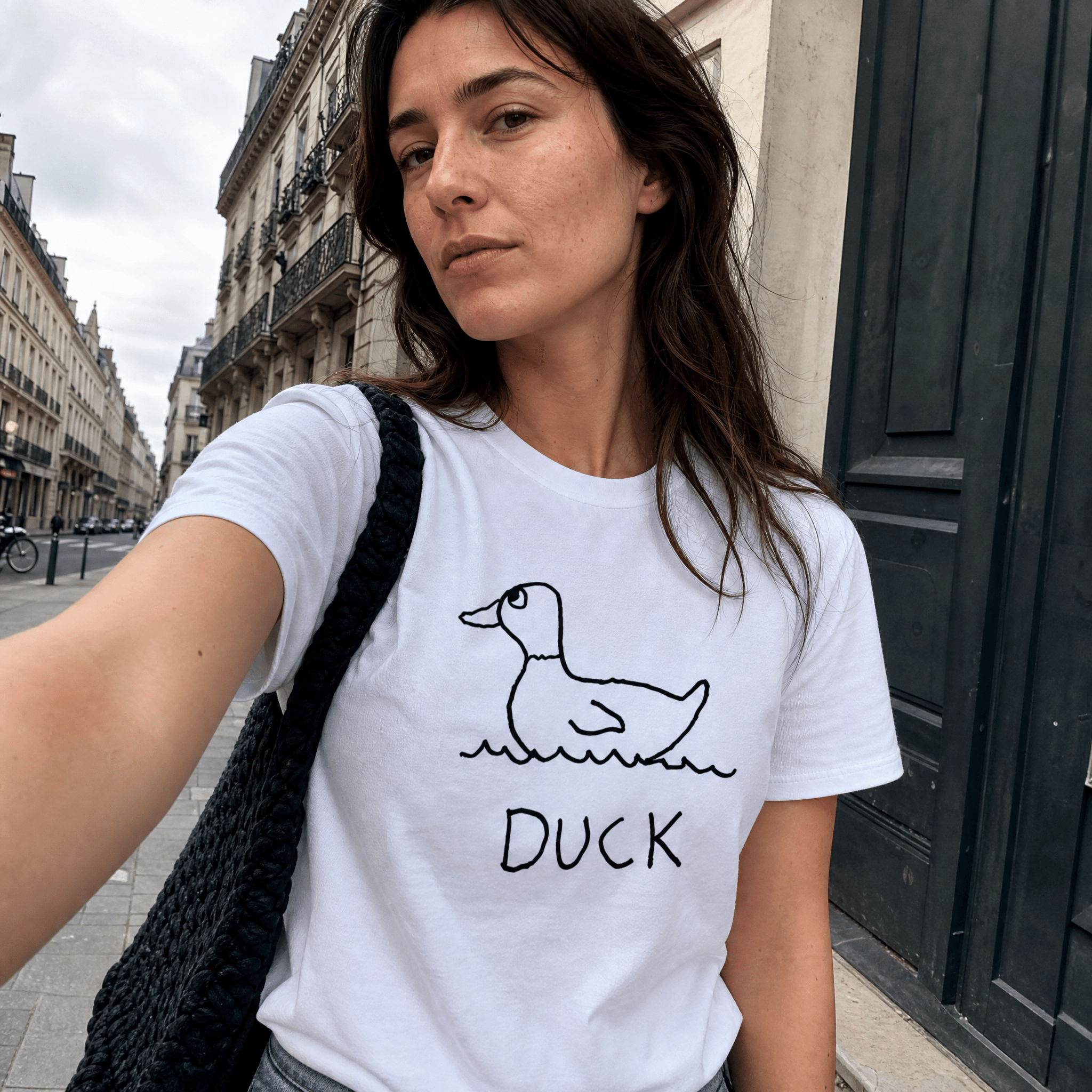 Woman taking a street selfie in a lo-fi Duck Women's Relaxed T-Shirt in white