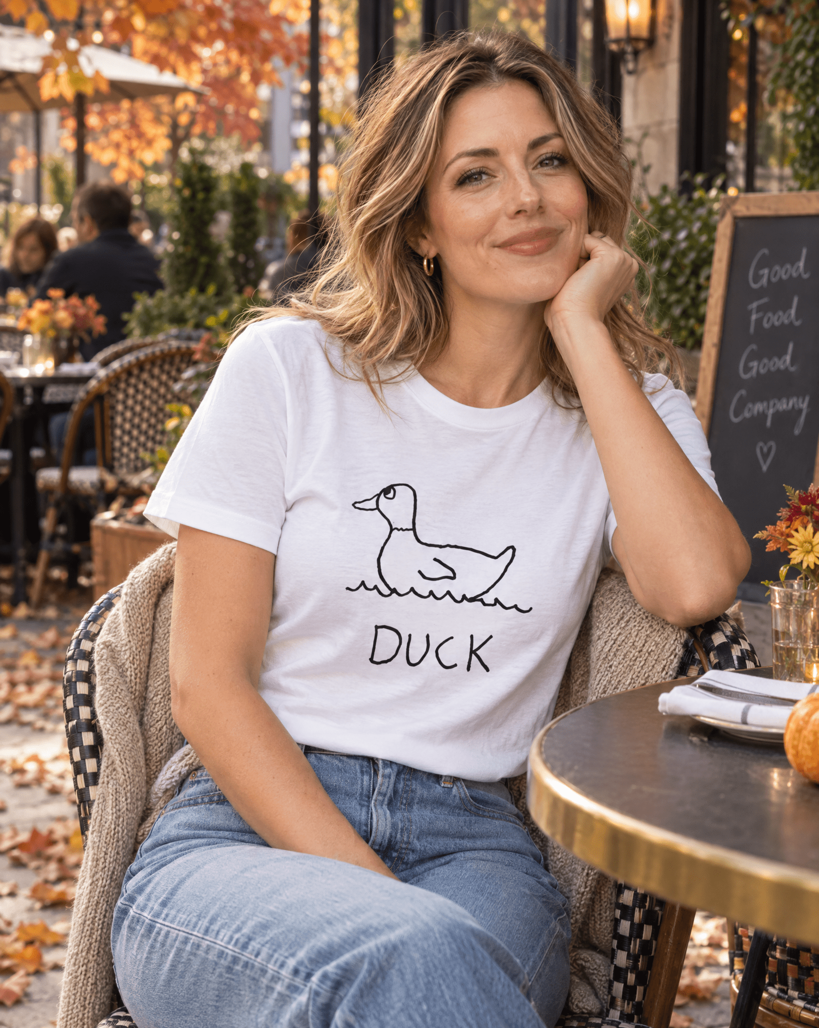 Sep 29 duck women's tee — autumn patio lifestyle photo