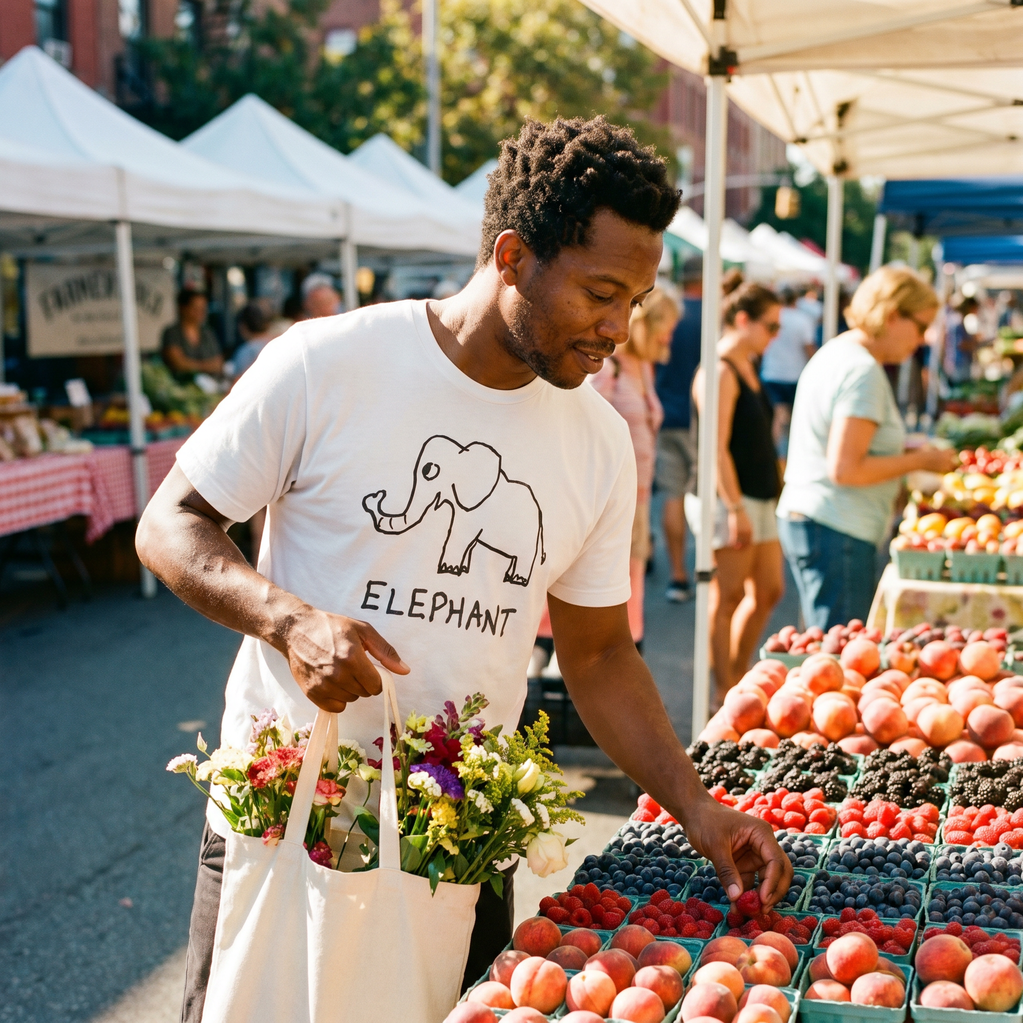 Man picking out fruit at a farmers market wearing a lo-fi Elephant Classic Tee