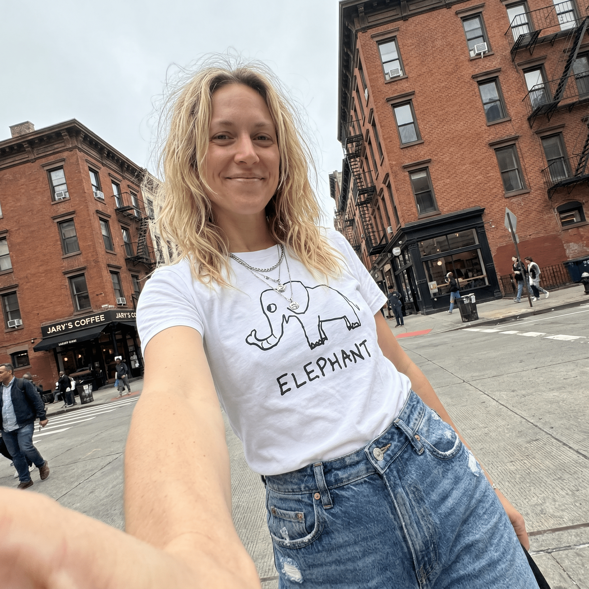 Woman taking a selfie on a city street wearing a lo-fi Elephant Women's Relaxed Tee