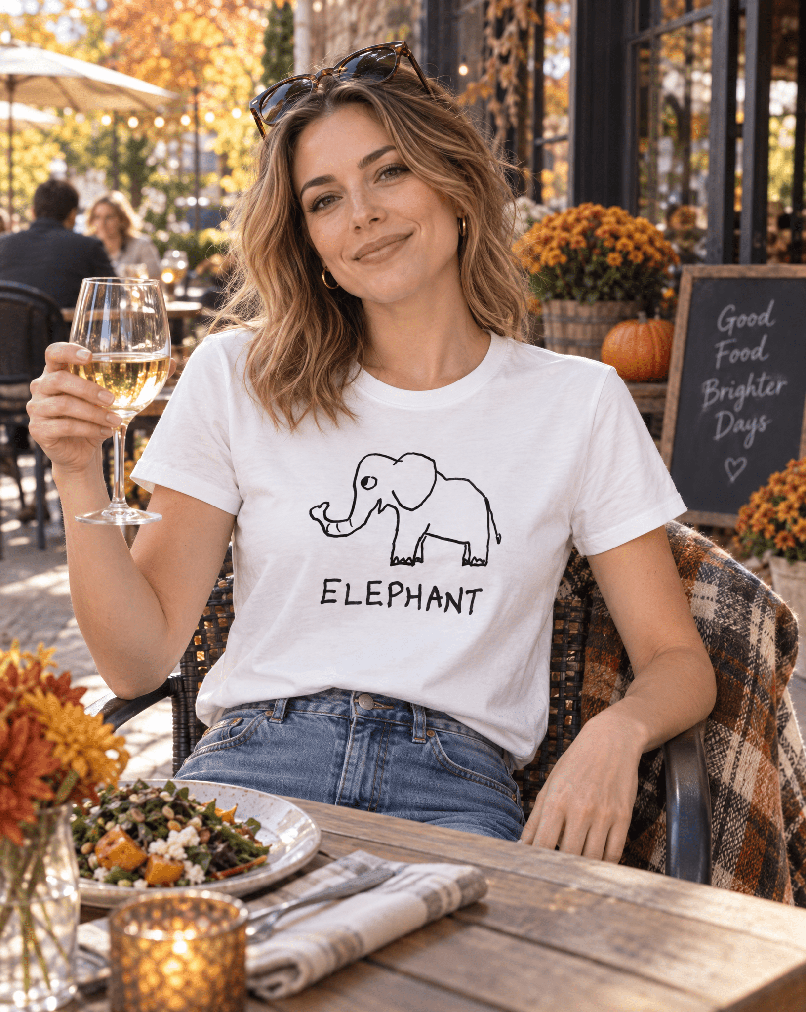 Sep 29 elephant women's tee — autumn patio lifestyle photo