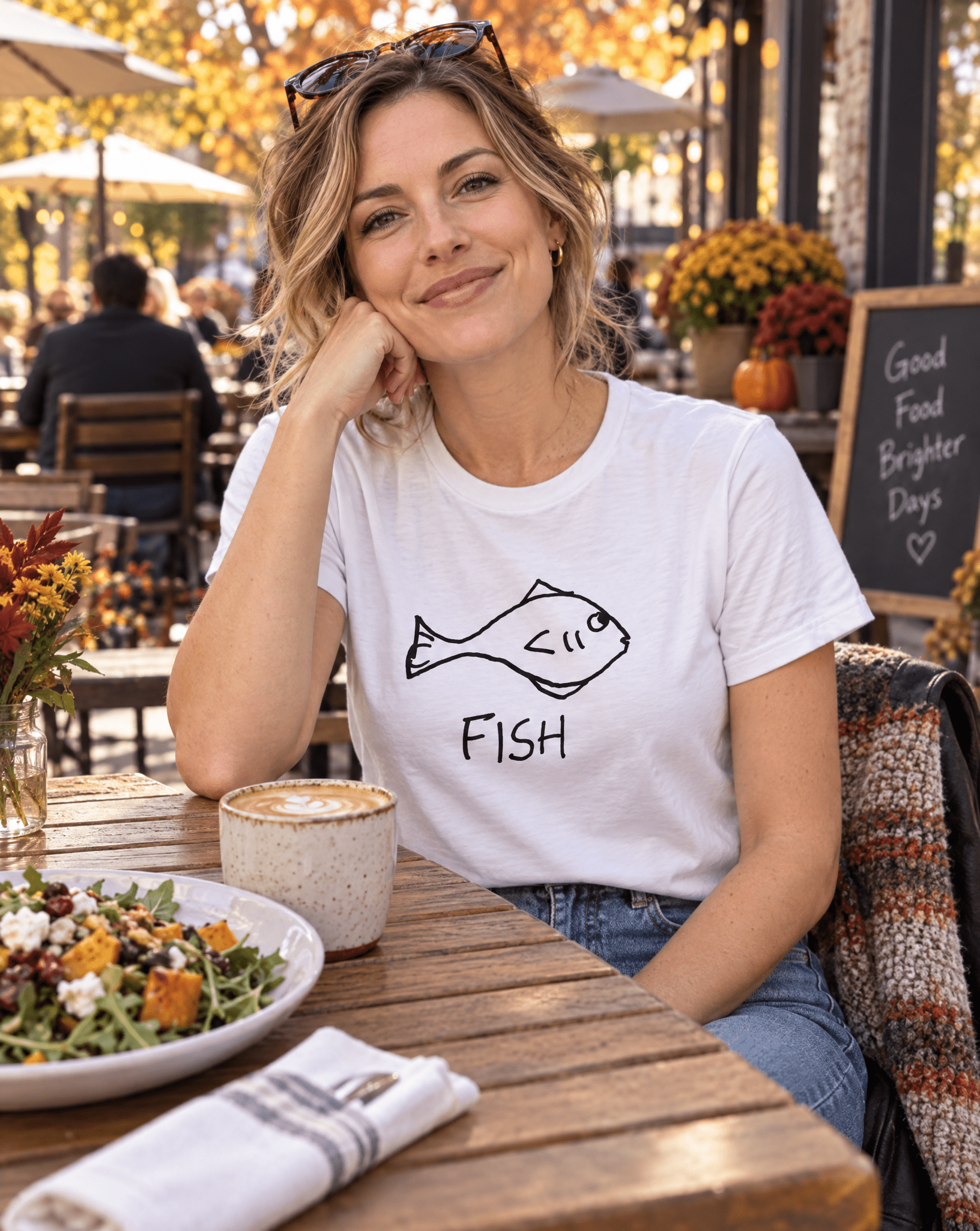 Sep 29 fish women's tee — autumn patio lifestyle photo