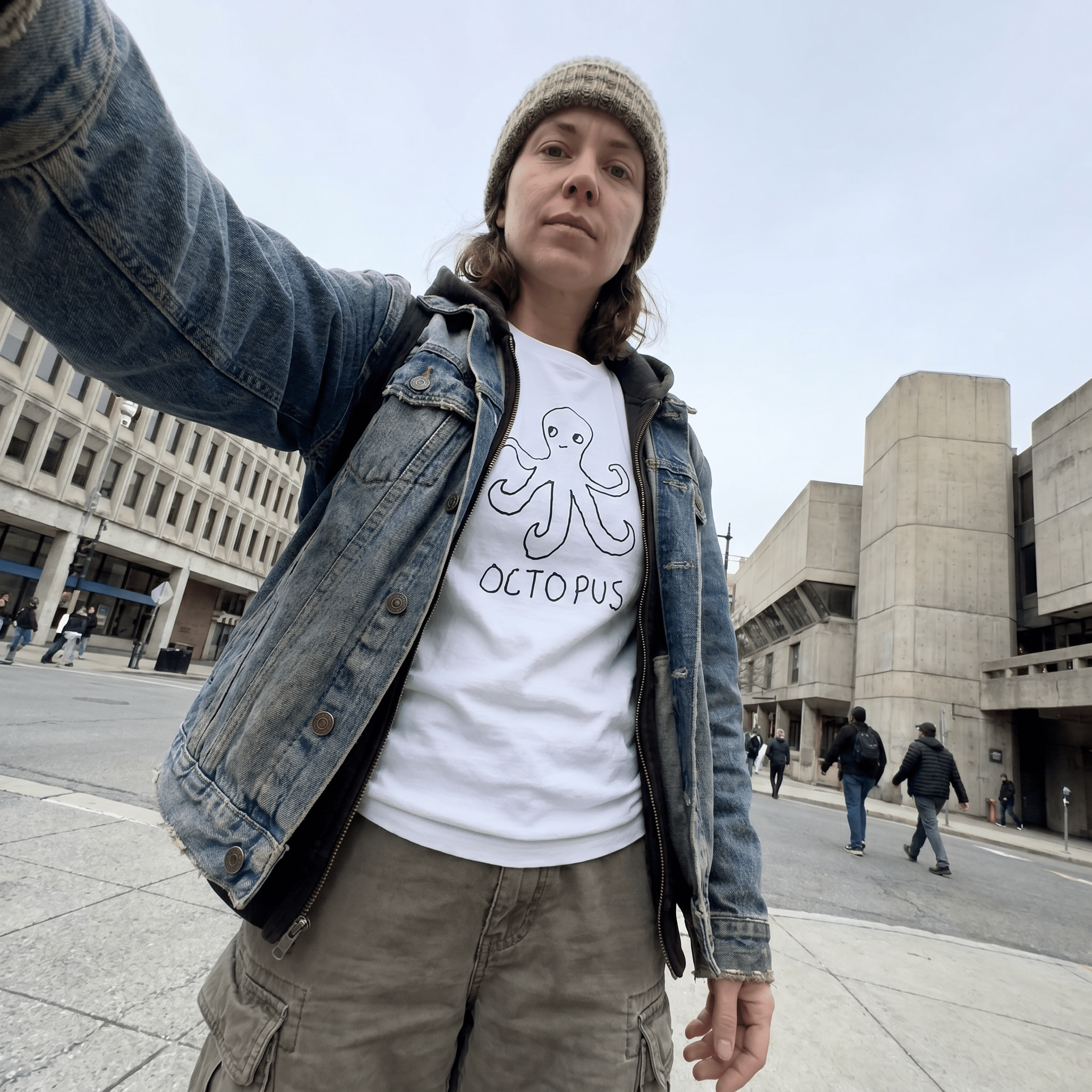 Woman taking a selfie on an urban street wearing a lo-fi Octopus Women's Relaxed T-Shirt in white