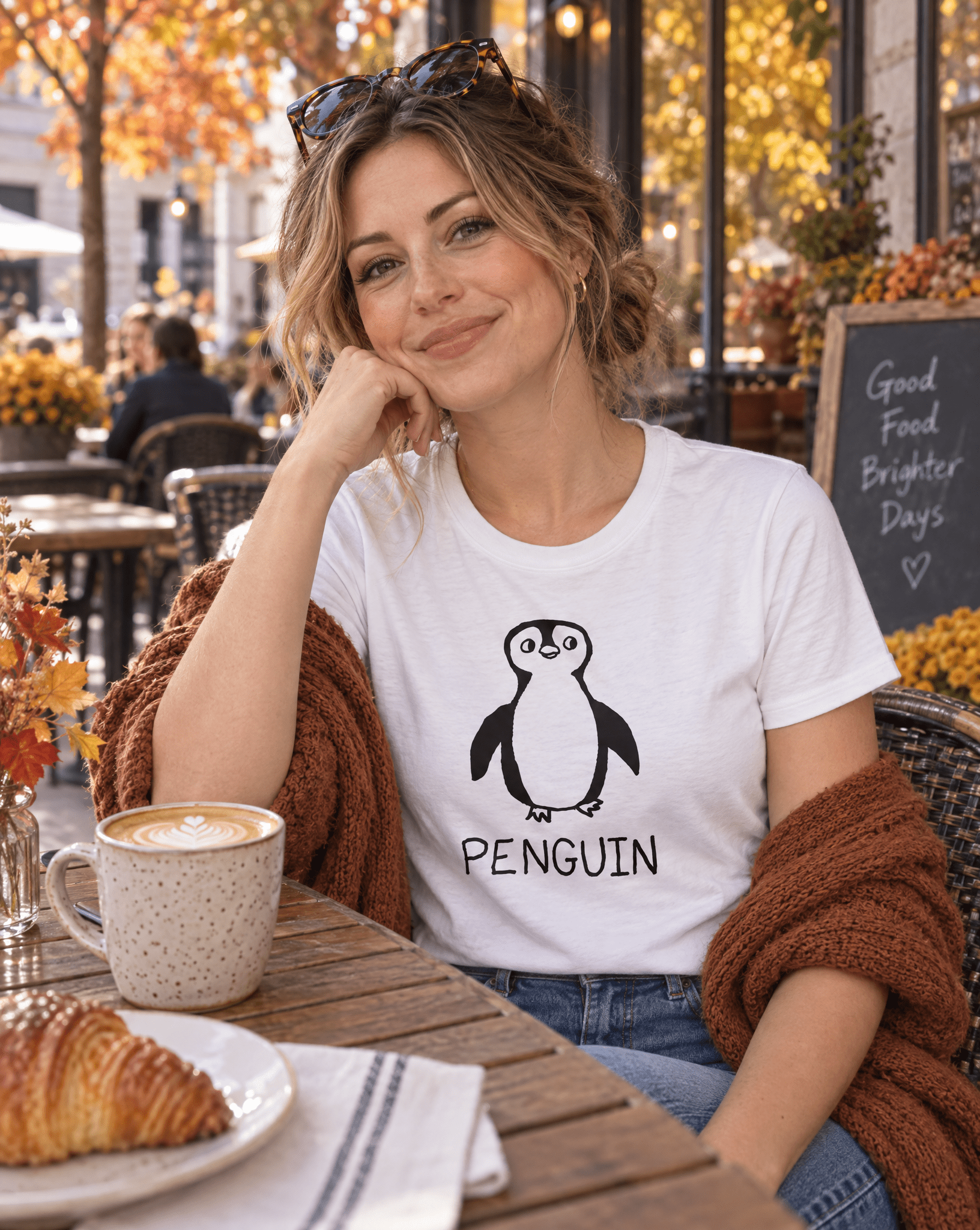 Sep 29 penguin women's tee — autumn patio lifestyle photo