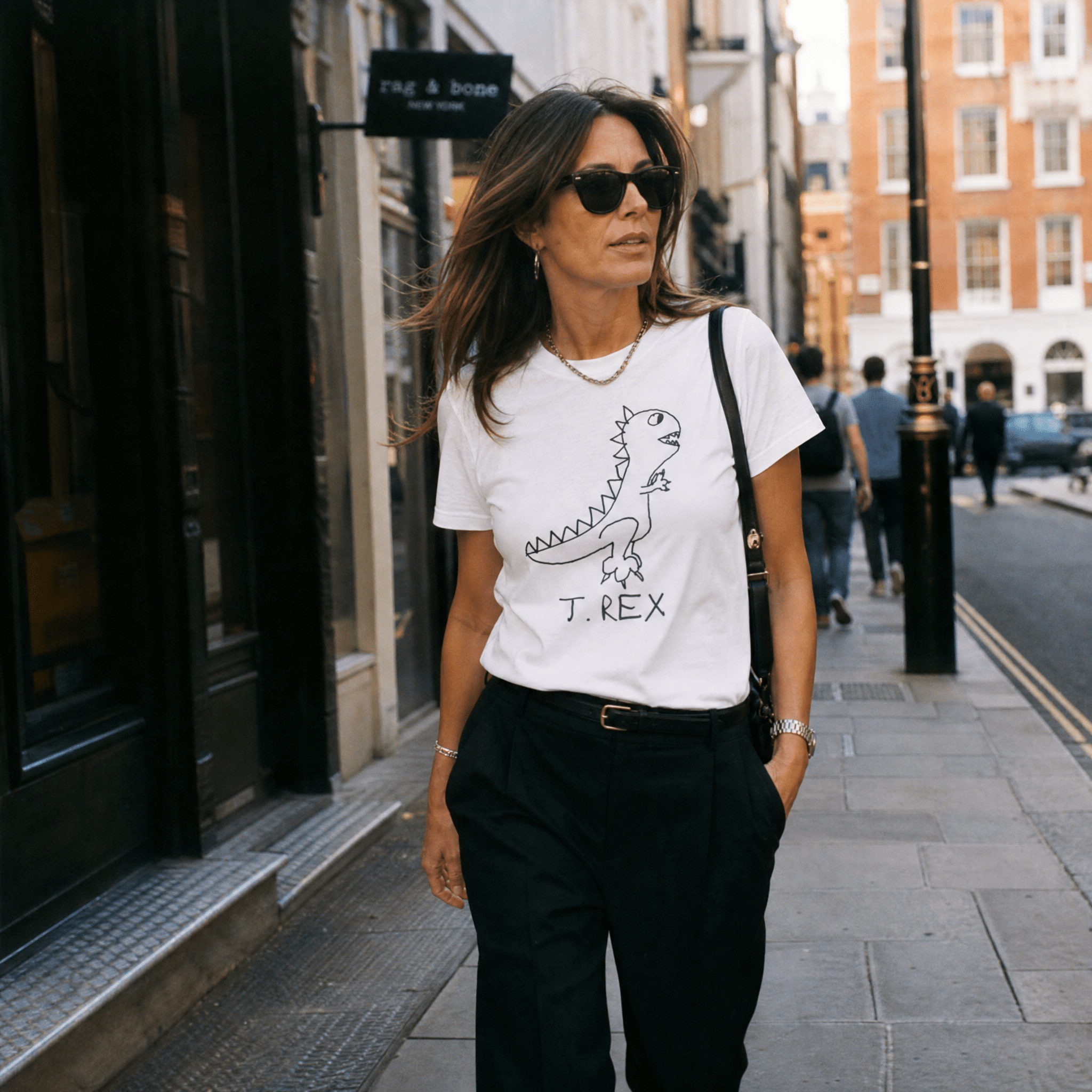 Woman walking a SoHo shopping street in a lo-fi T. Rex Women's Relaxed T-Shirt in white