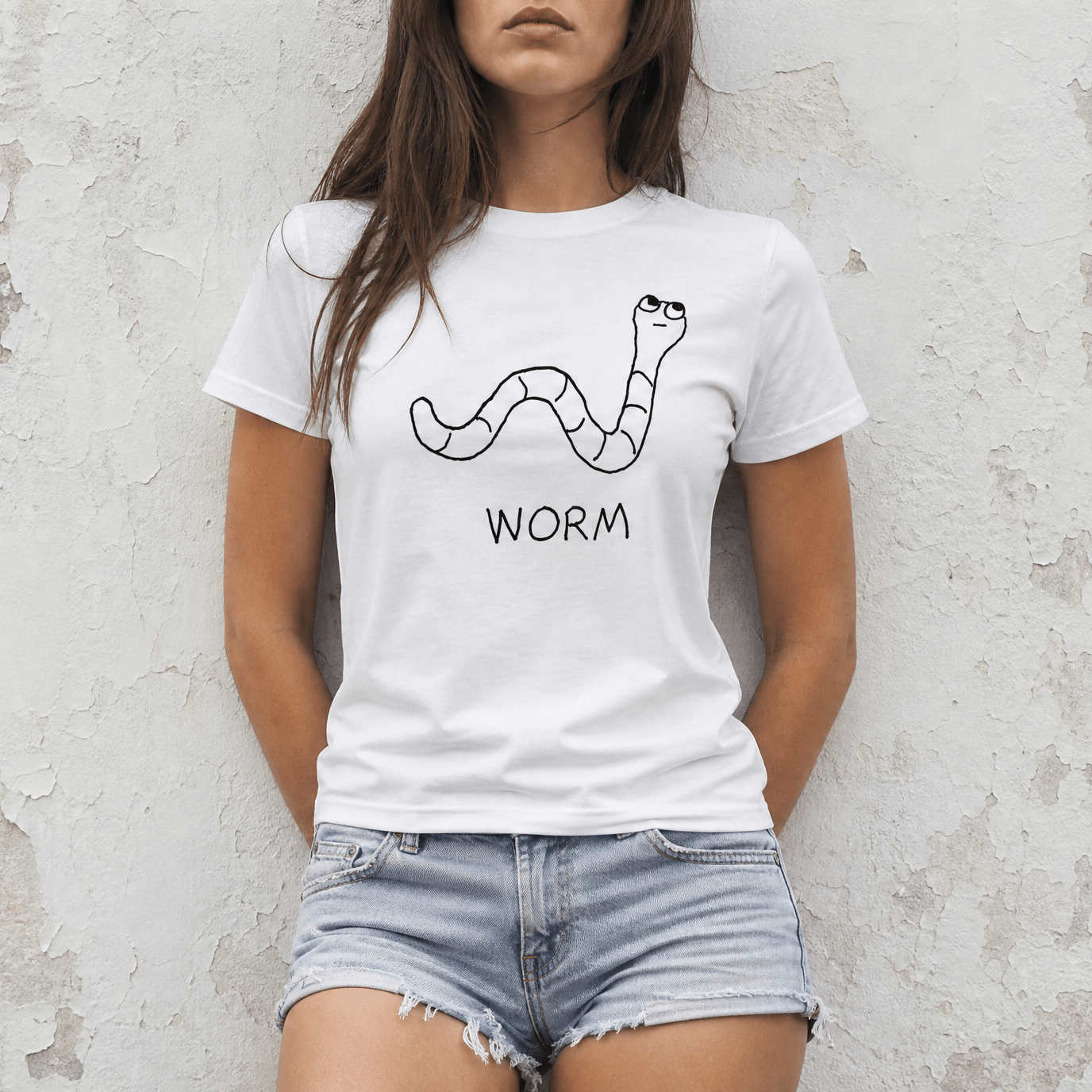 Woman street-style torso shot in a lo-fi Worm Women's Relaxed T-Shirt in white