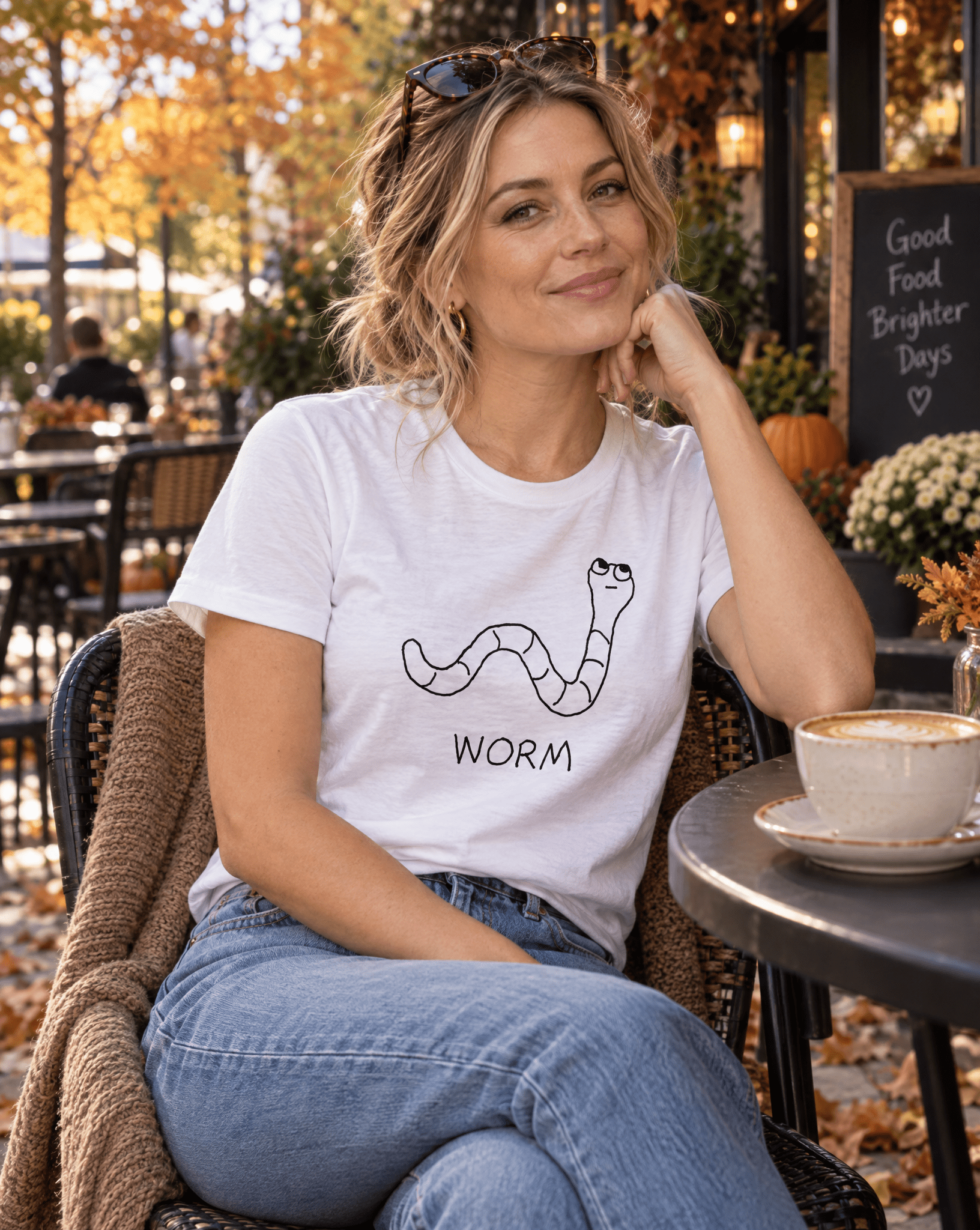 Sep 29 worm women's tee — autumn patio lifestyle photo