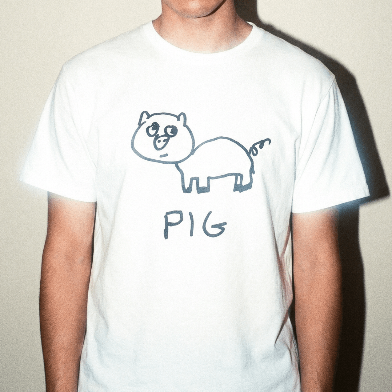 Man wearing a lo-fi Pig Classic Tee in white against a neutral studio backdrop