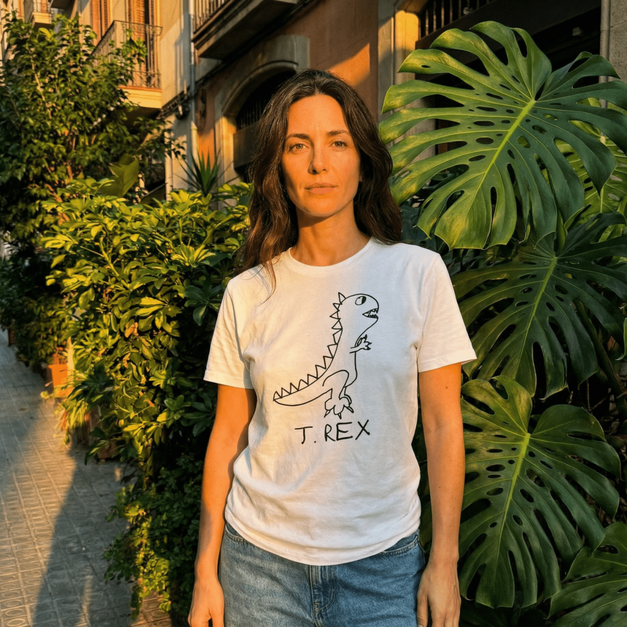 Woman in a golden-lit European alley wearing a lo-fi T. Rex Classic Tee